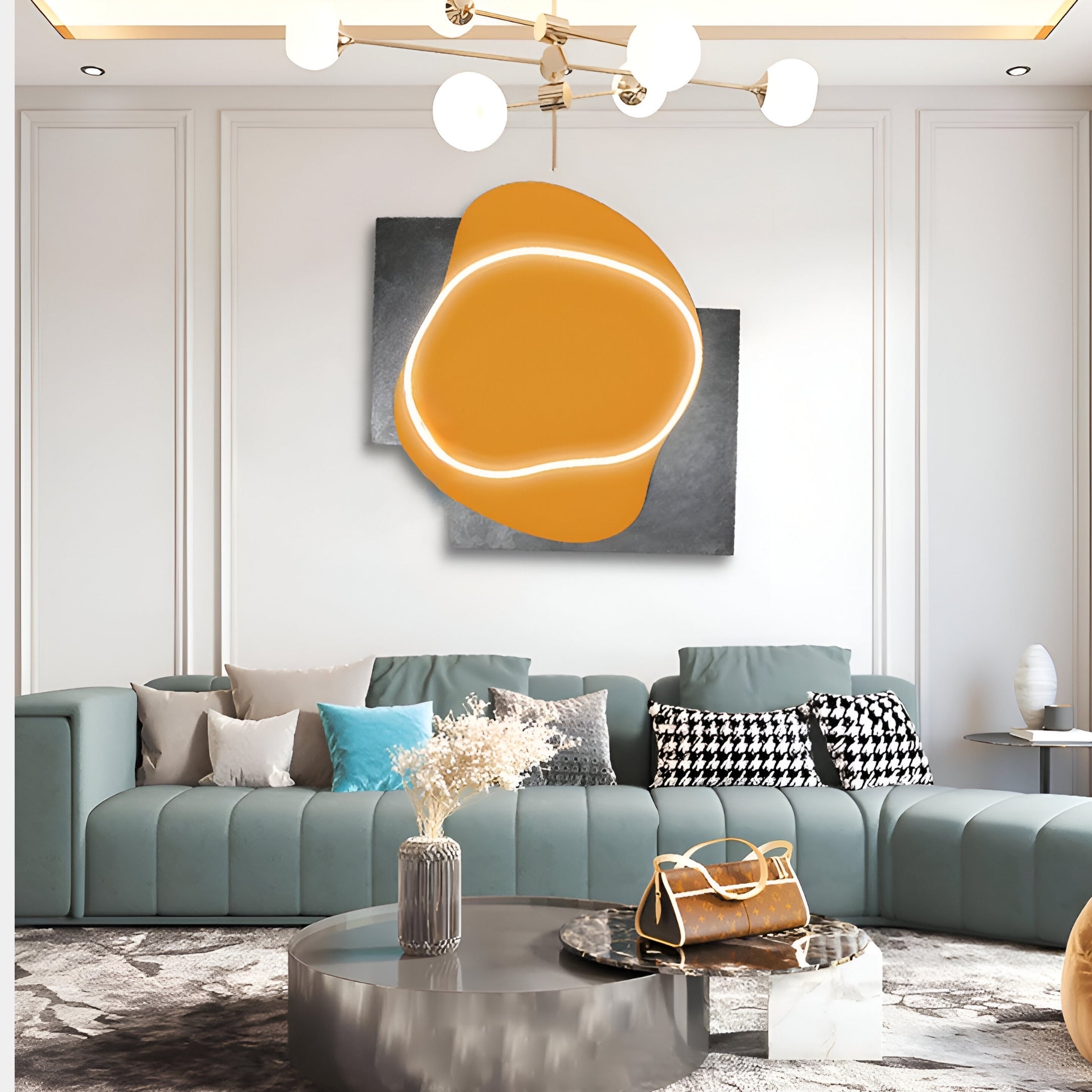 A modern living room with a teal sectional sofa, assorted cushions, and a round coffee table adorned with dried flowers features the Giant Sculptures Gleam Amber Glow 3D Leather LED Wall Art above the sofa under a contemporary chandelier.