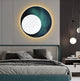 A modern bedroom showcases the Flaria Emerald 3D LED Wall Art by Giant Sculptures, featuring a design akin to a lunar eclipse with geometric sandstone elements. The bed has white and gray bedding, and a contemporary dual-globe lamp hangs beside a small table topped with books.