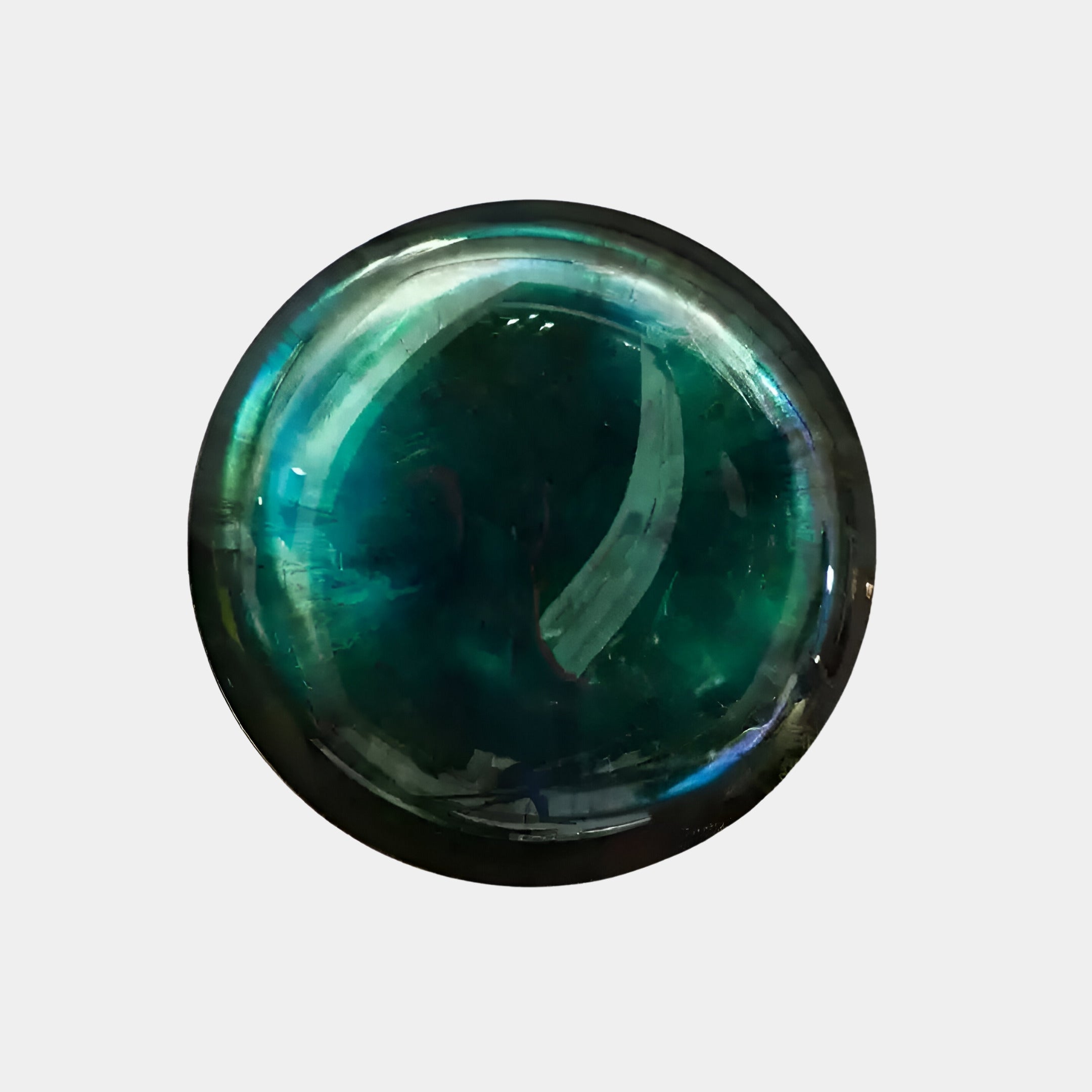 A Vitreon 3D Aquamarine Crystal Porcelain Wall Art by Giant Sculptures features a shimmering spherical design with a deep green hue and subtle blue undertones, set against a plain light gray background that evokes elegant interior décor.