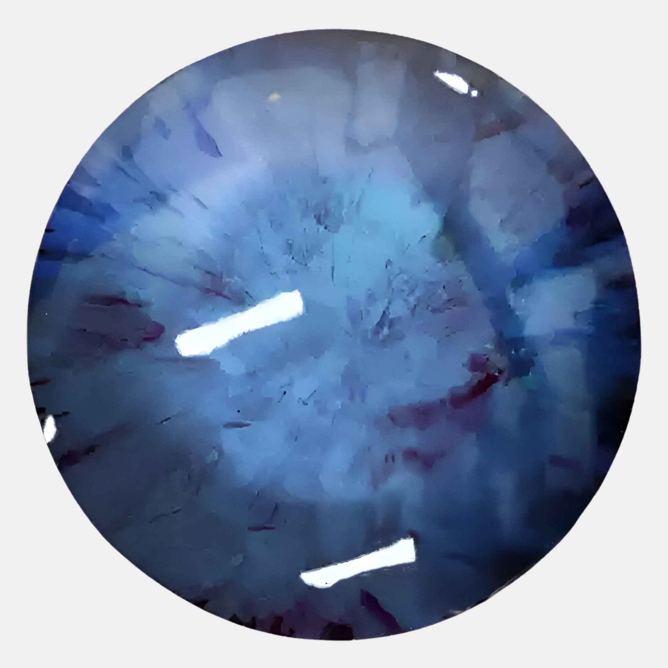 A close-up of a round blue gemstone with unique internal patterns and reflections—ideal for contemporary spaces as the Vitreon 3D Sapphire Crystal Porcelain Wall Art by Giant Sculptures.