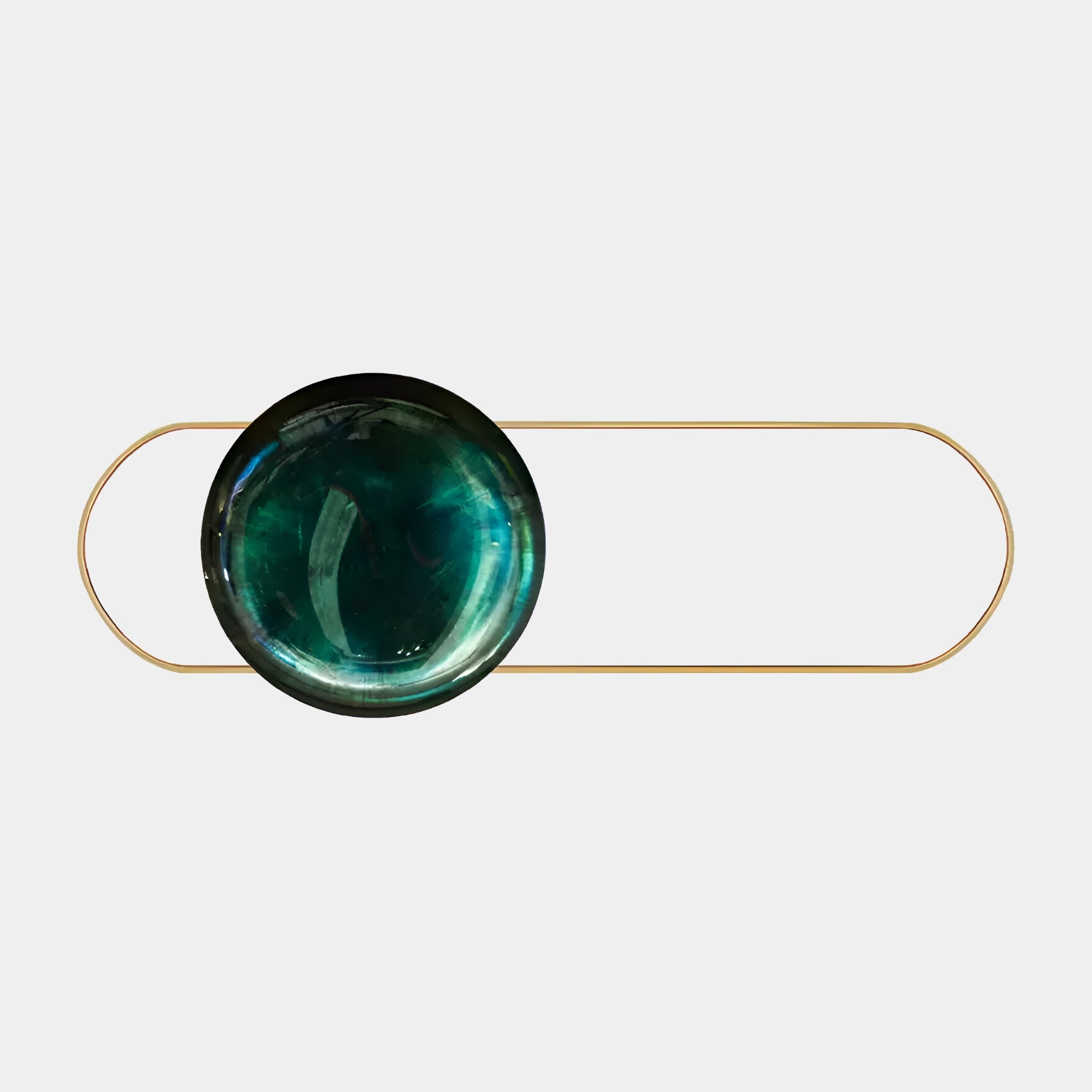 The Vitreon 3D Emerald Crystal Porcelain by Giant Sculptures features an emerald green glass orb elegantly set in a thin gold frame. This minimalist and modern wall art, against a light gray background, evokes an elongated oval design with subtle LED lighting to enhance its allure.