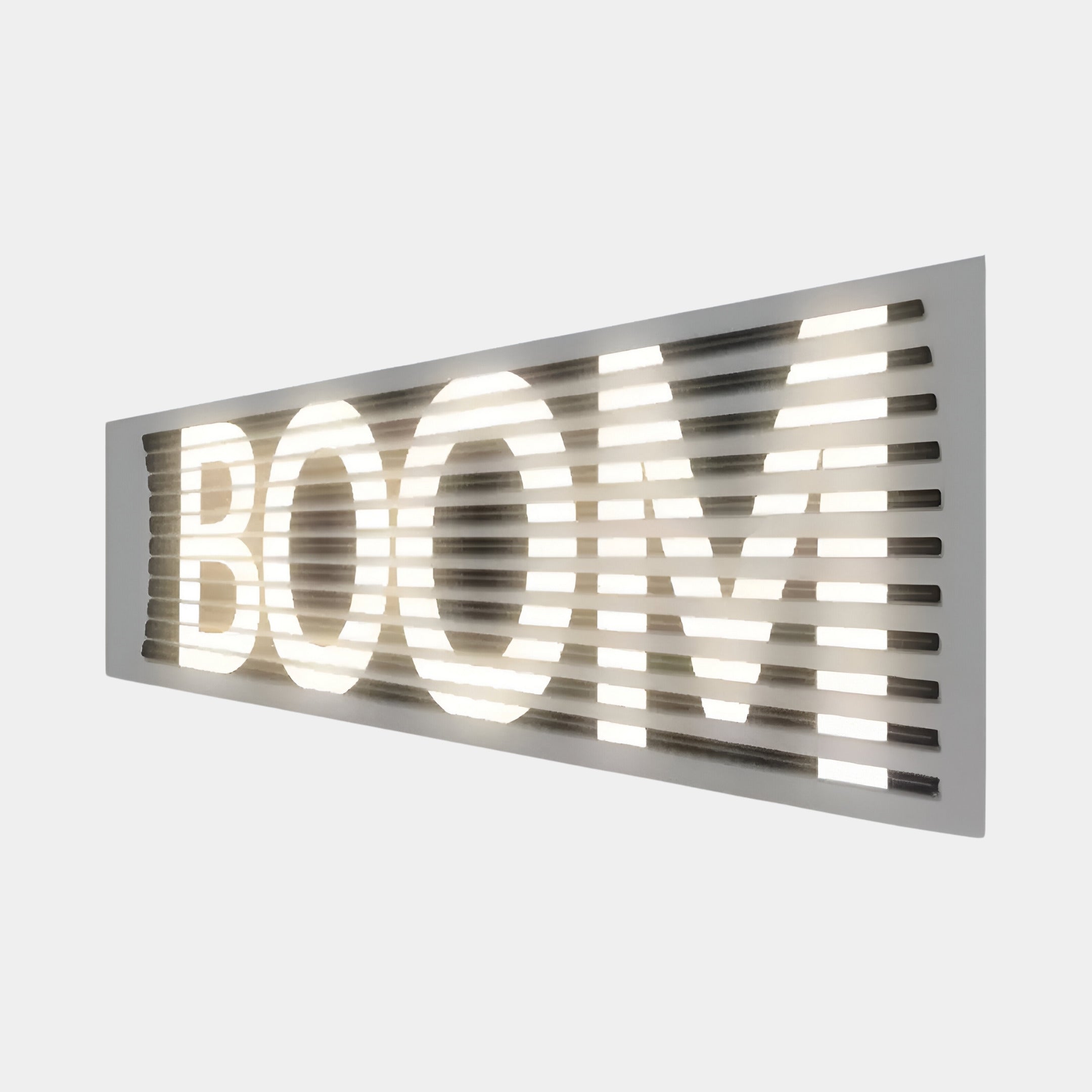 Industrial-style LED wall art with the word BOOM in a bold typographic design, enhancing a minimalist lounge setting with a statement piece.