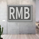 Contemporary wall art displaying the letters RMB with a layered slat design, perfect for adding a stylish accent to minimalist interiors.