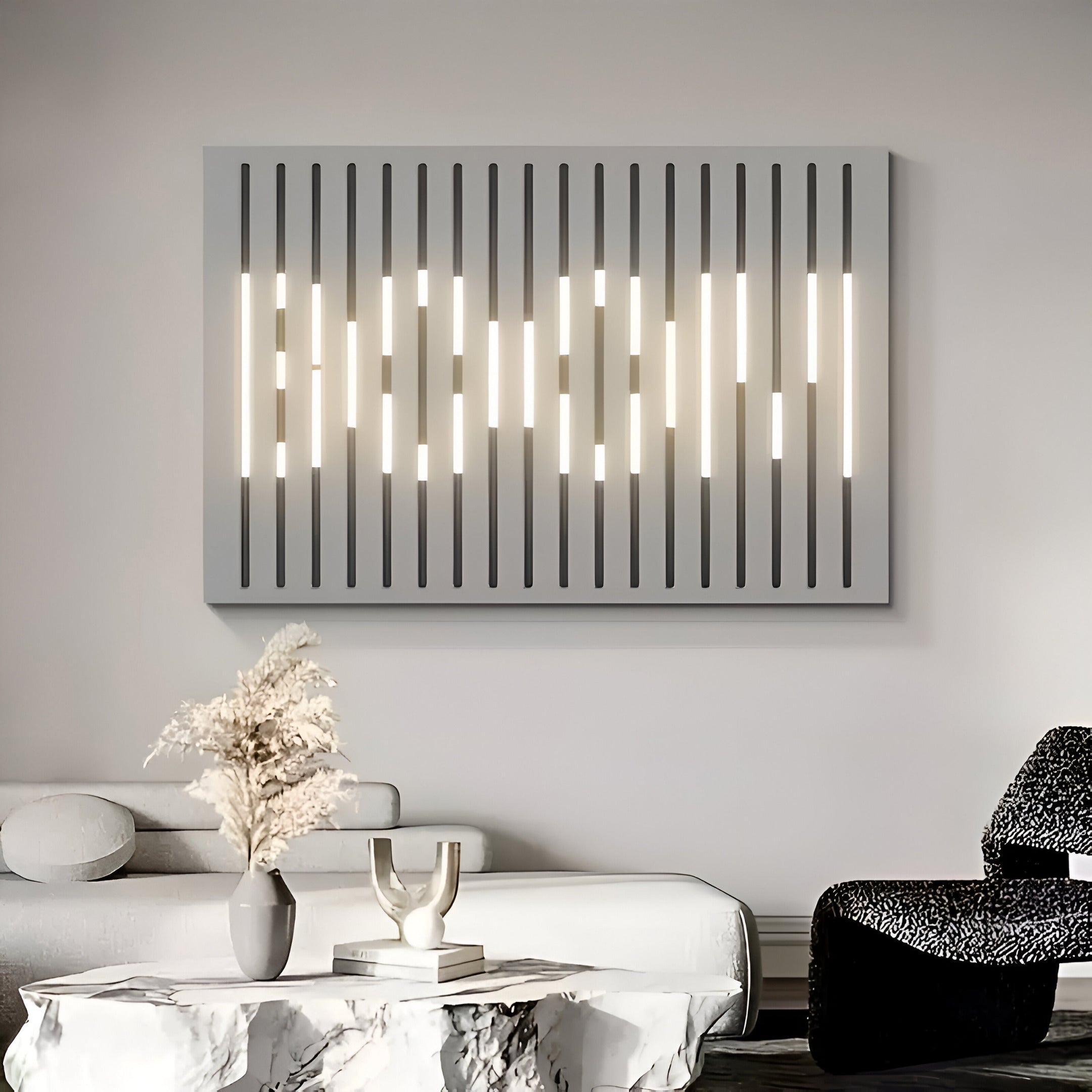 A modern living room showcases a minimalist wall light with vertical lines, complementing the Verlux Linear Harmony 3D LED Wall Art by Giant Sculptures. Below, a white sofa and marble coffee table hold a vase with decorative items, while a textured armchair adds contrast.