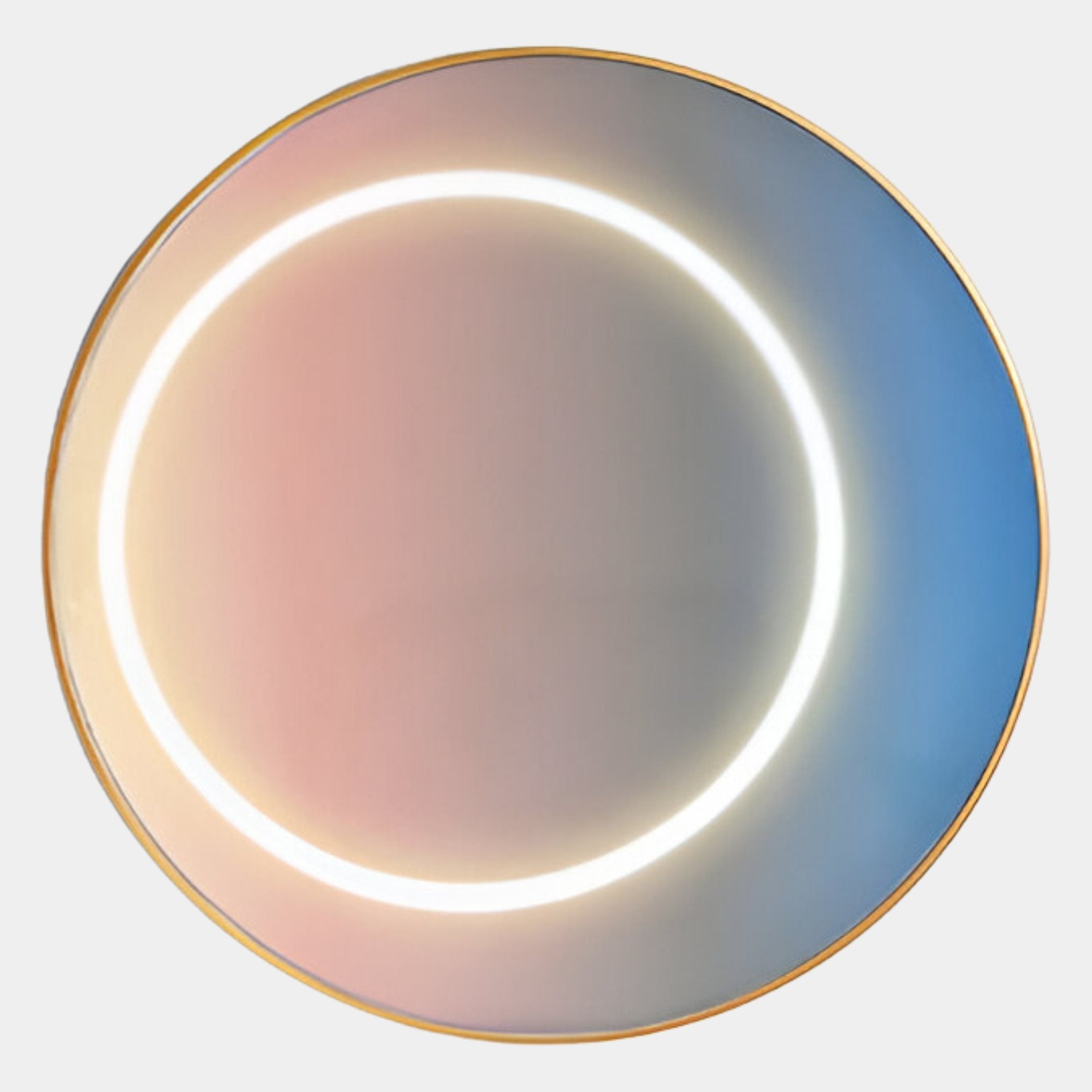 A round mirror with a thin gold frame reflects soft pink and blue gradients, inspired by Giant Sculptures’ Aurora Blush Mist Crystal Porcelain LED Wall Art, and features a glowing white circular LED light at its center.