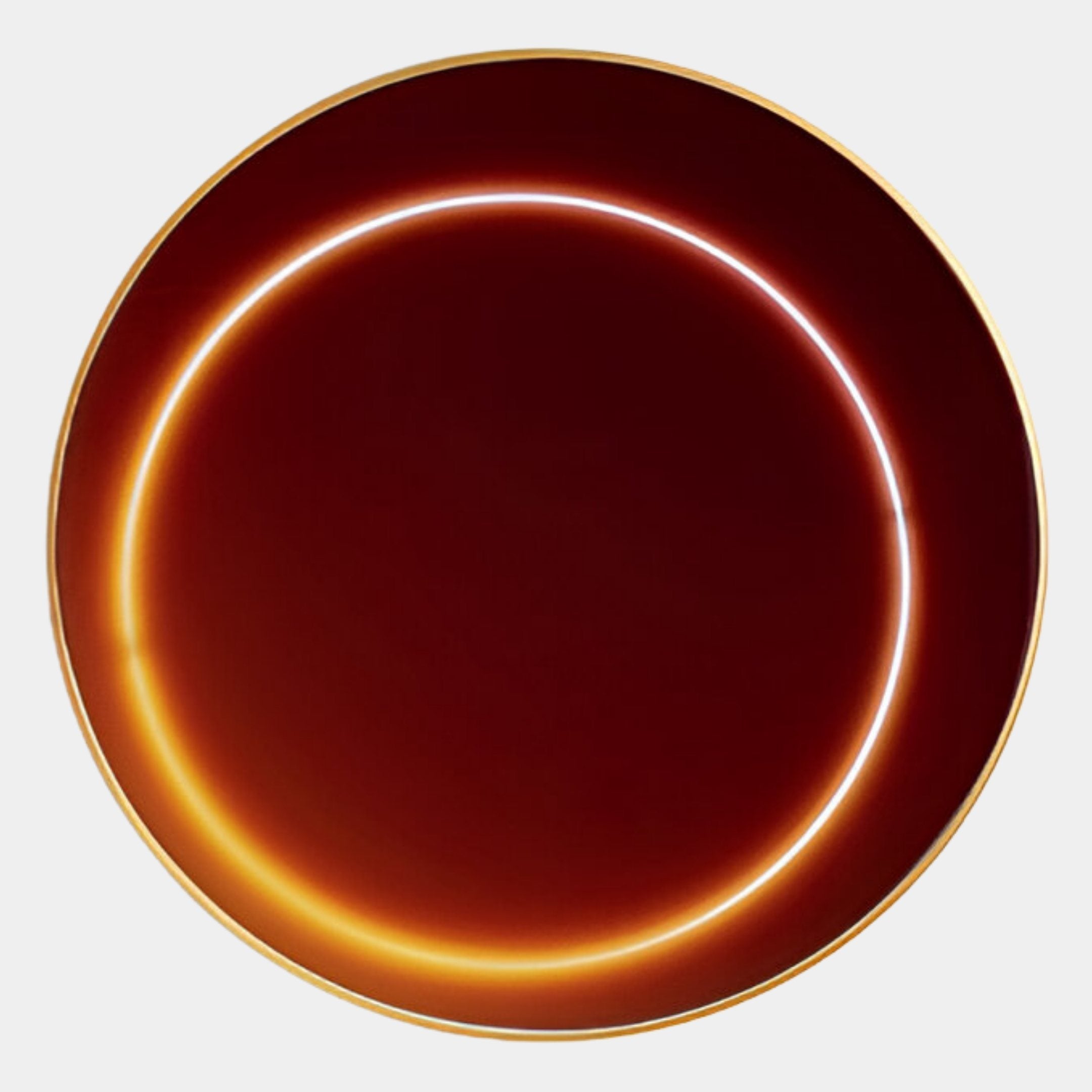 A round, dark red crystal porcelain plate with a gold rim and two glowing, curved reflections evokes the modern style of Giant Sculptures’ Aurora Ember Glow Crystal Porcelain LED Wall Art against a plain light gray background.