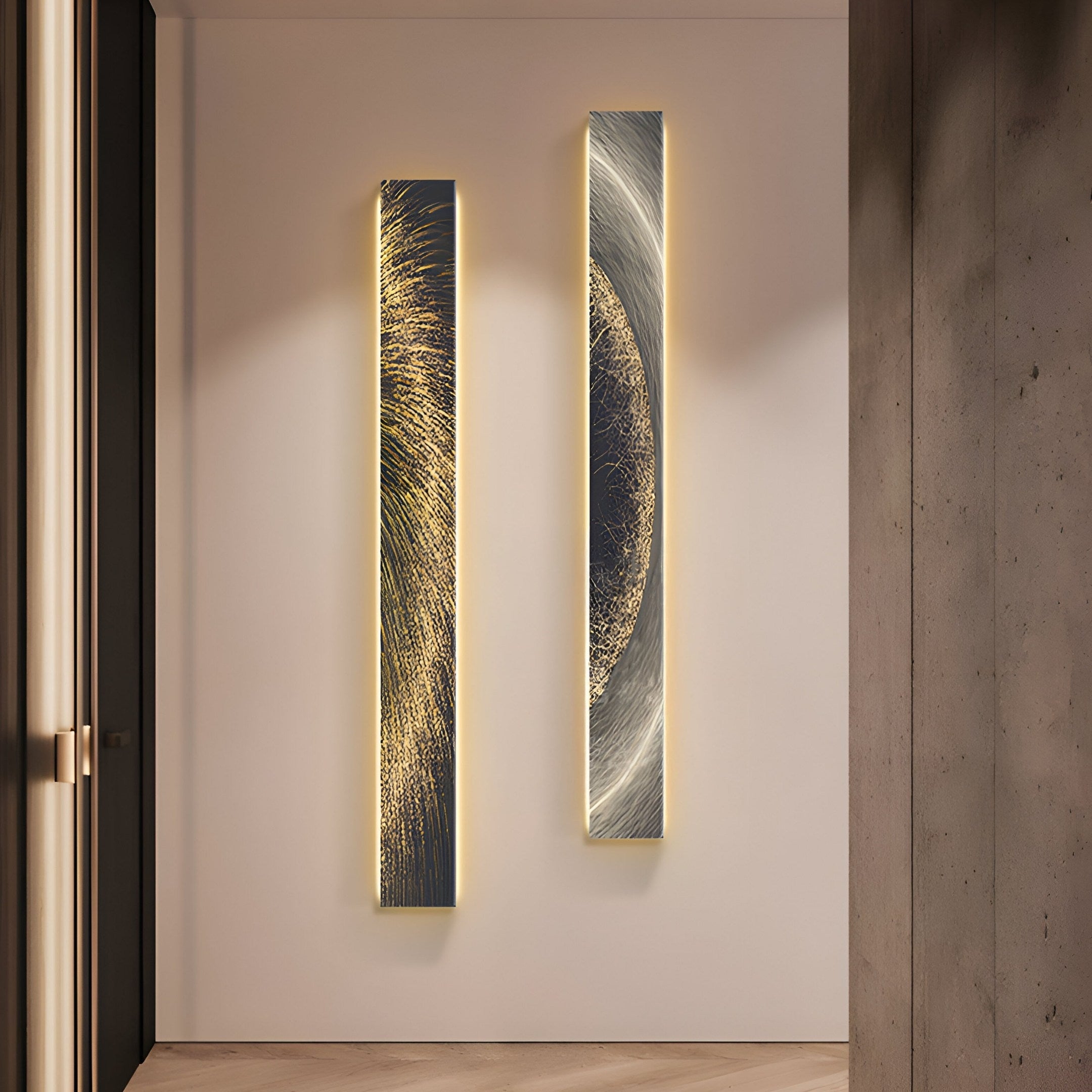 The Radiance Golden Canvas LED Wall Art by Giant Sculptures features two vertical, rectangular lights with abstract gold and silver designs, casting a glowing aura on the light-colored wall in the modern room with a concrete column on the right and a door frame visible to the left.