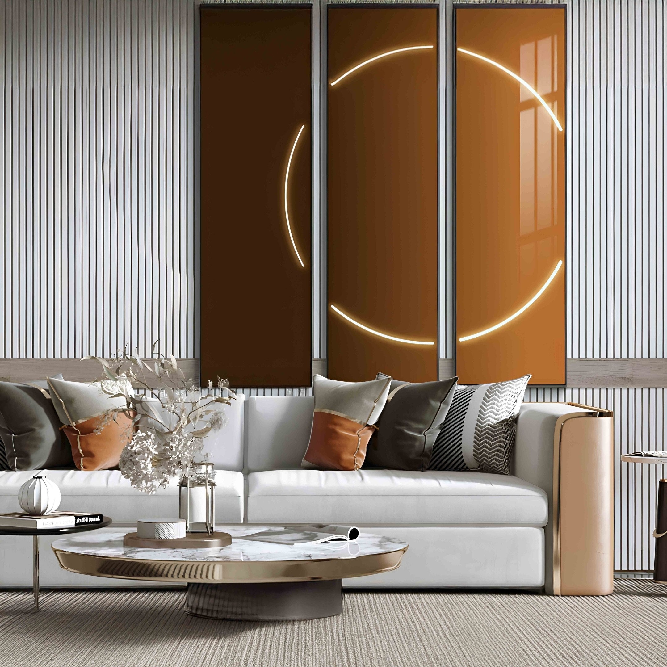 A modern living room showcases a white sectional sofa with brown and patterned cushions, a round coffee table on a textured rug, and Giant Sculptures Helios Copper Crystal Porcelain LED Wall Art, featuring illuminated circular designs that complement the neutral metallic palette.