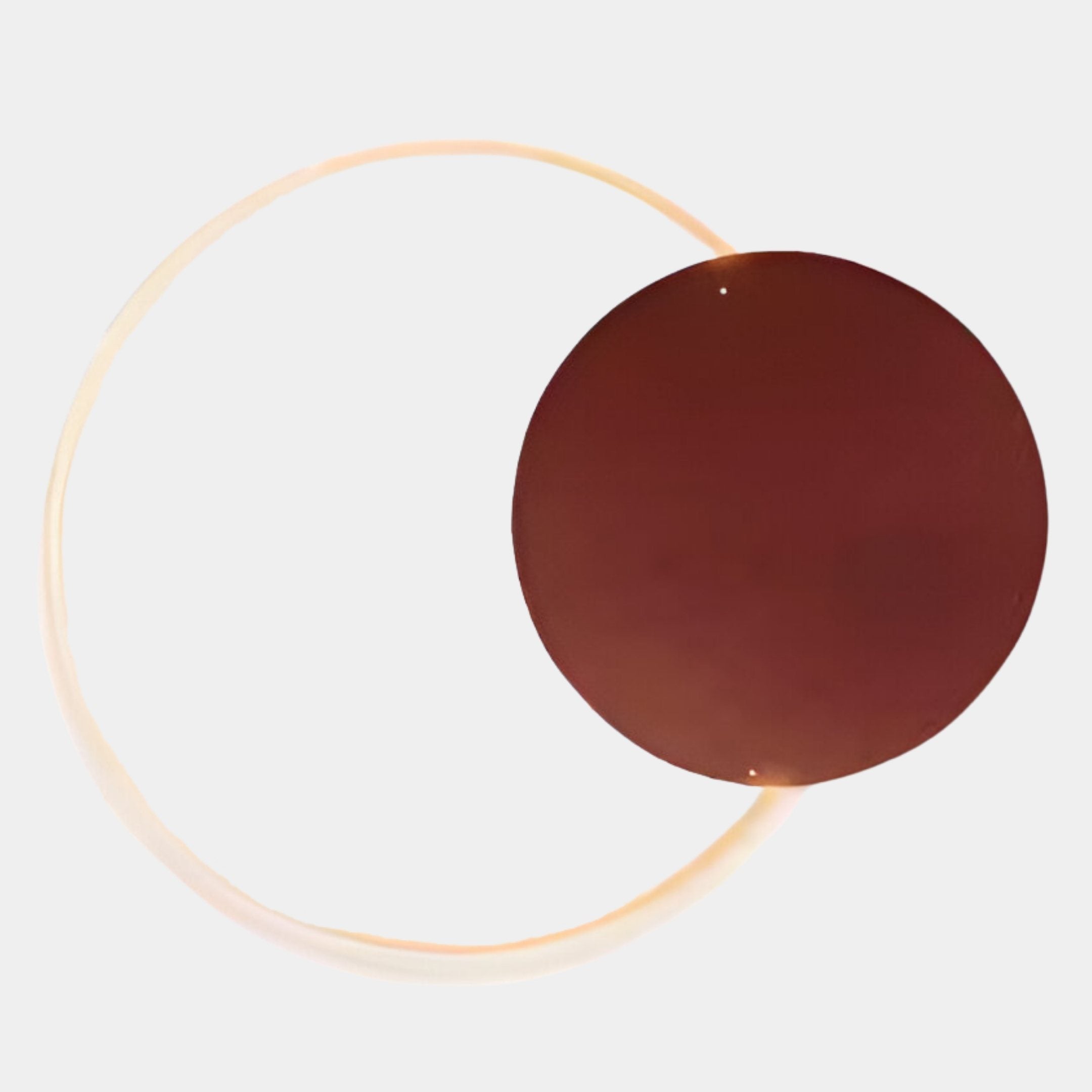 The Soluna Copper Acrylic 3D LED Wall Art by Giant Sculptures features a large metallic LED tube ring intersecting a dark brown circle on white, forming a minimalist, abstract design.