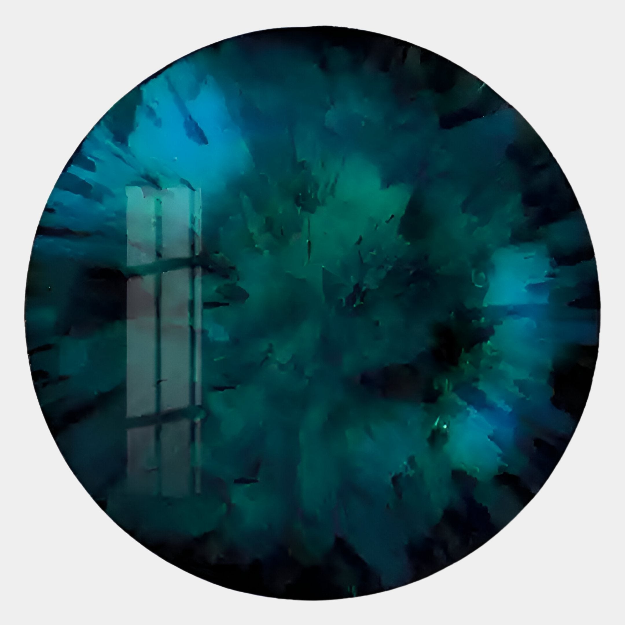 A circular teal-blue abstract image, resembling Giant Sculptures Lumea Textured Turquoise 3D LED Crystal Porcelain Wall Art, features a burst pattern from the center and a window reflection on the left.