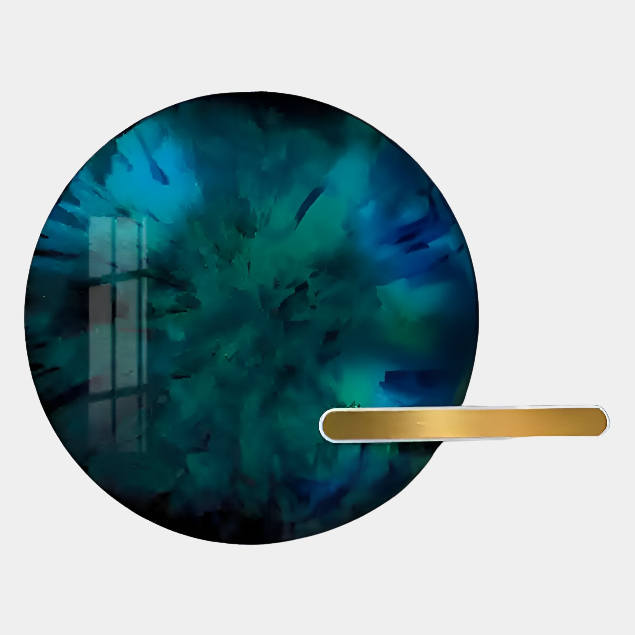 The Giant Sculptures Lumea Abstract Turquoise 3D LED Crystal Porcelain Wall Art features a round teal and dark blue explosion design, accented by a gold bar on the lower right and a subtle window reflection on the left.