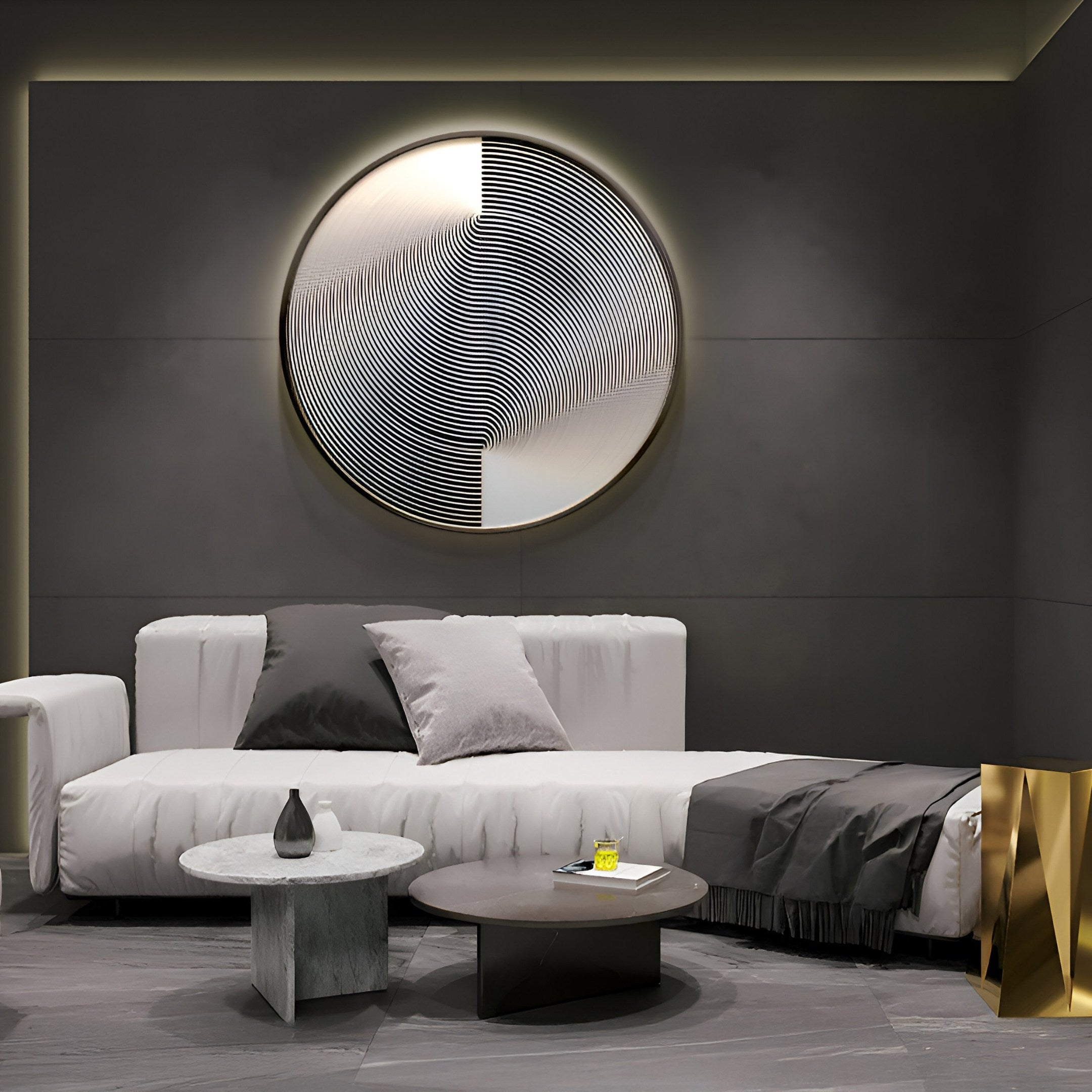 A modern living room showcases a white couch with gray and black pillows, two circular coffee tables, and a gold accent table. Hanging on the dark wall is Giant Sculptures Astral Silver Crystal Porcelain LED Wall Art, illuminating the space and enhancing its modern vibe.