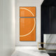 An Enigma Amber Sunrise LED Wall Art by Giant Sculptures adorns a contemporary room, featuring an orange abstract design with white curved lines. The space is completed with white marble flooring, a sleek black panel, and a gold-accented marble counter, evoking the warmth of an amber sunrise.