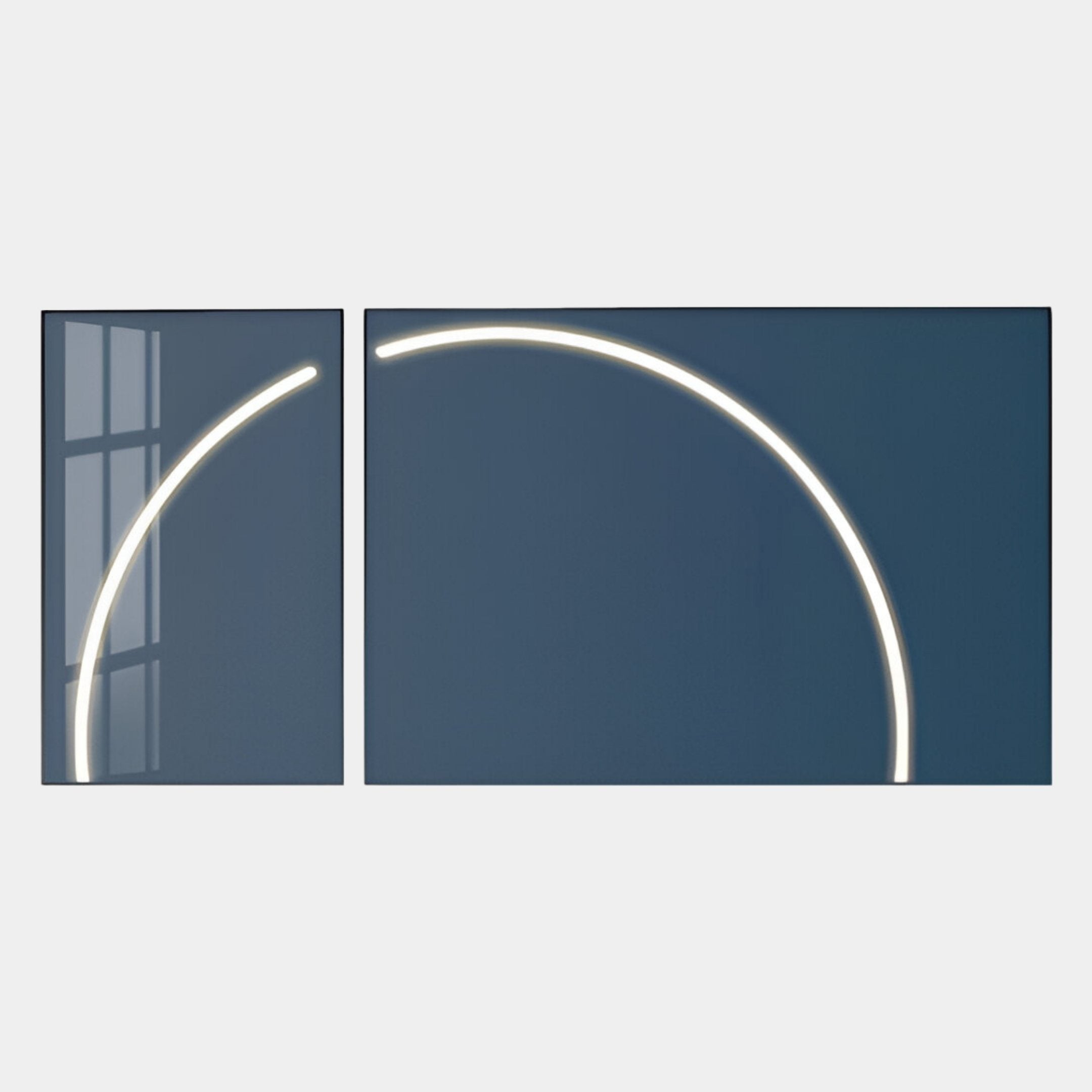 Two Enigma Midnight Teal LED Wall Art panels by Giant Sculptures are displayed side by side, each featuring a glowing white curved line; together they form a bold geometric arc, with window reflections visible on the left panel.