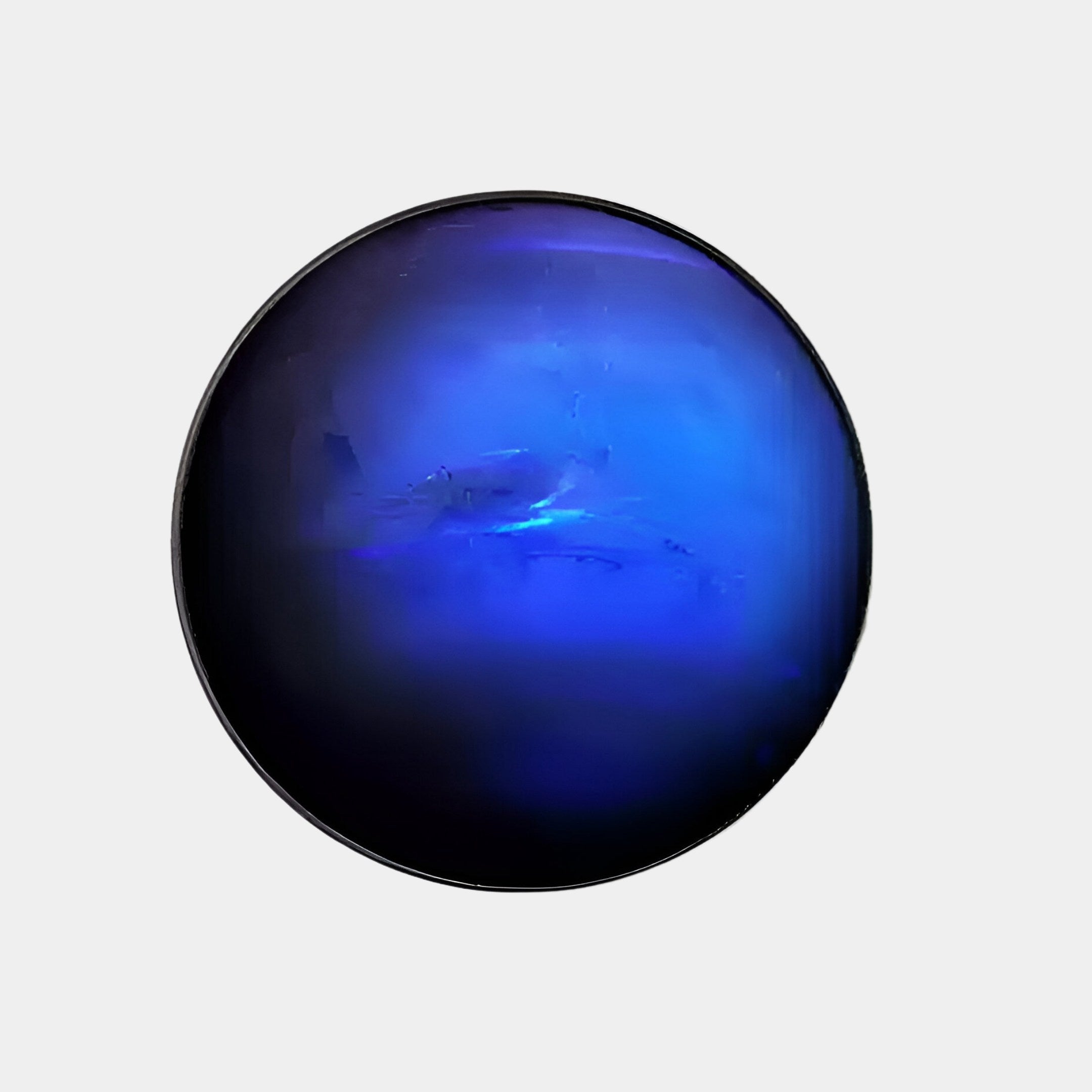 The Galaxia Neptune Crystal Porcelain LED Wall Art by Giant Sculptures features a dark blue, round design with a soft gradient from deep blue at the edges to lighter blue center, resembling a planet or orb, set against a plain light gray background.