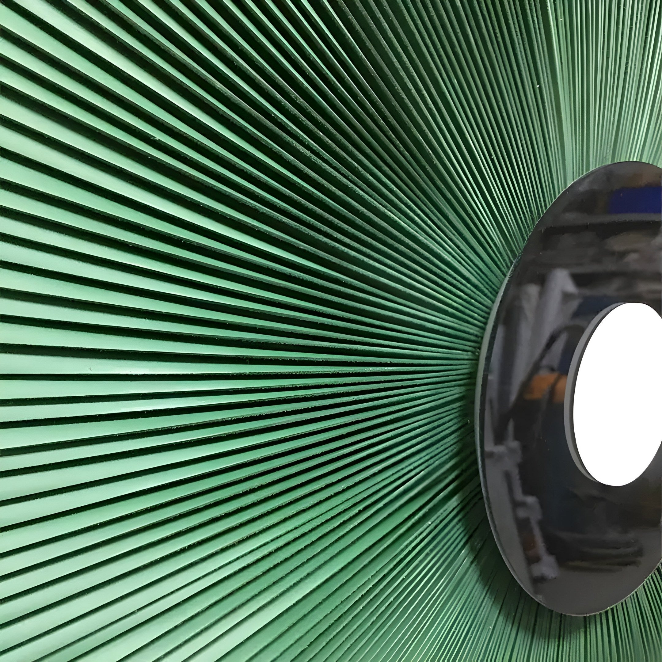 The Vanguard Jade Surge Leather 3D LED Wall Art by Giant Sculptures showcases a large green circular piece with radiating lines and a reflective black disc at the center, resembling sun rays or an eye, adding chic elegance to modern interiors.