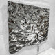 Lumineris Silver Melted Wave Metal 3D Wall Art in mirror-polished stainless steel, shown at an angle with a rippled, liquid-like surface and elongated drip, mounted on a plain white wall.