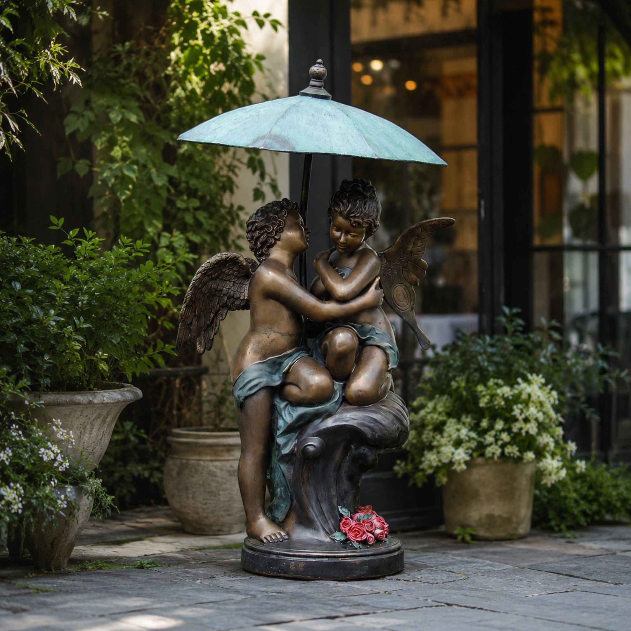 Large Classical Cherubs Under Parasol Bronze Sculpture, 170cm, two winged cherub figures embracing beneath a verdigris parasol on a garden patio setting.
