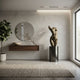 Large Contemporary Abstract Female Torso Bronze Sculpture by Giant Sculptures on a black cylindrical plinth in a minimalist entryway with mirror and console.