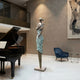 Large Contemporary Violinist Bronze Sculpture by Giant Sculptures, 220cm elongated female figure with verdigris dress holding a violin, displayed beside a grand piano.