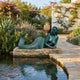 Life-Size Classical Reclining Mermaid Bronze Sculpture by Giant Sculptures with verdigris patina, propped on forearms beside a stone-edged garden pool.