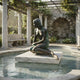 Life-Size Classical Seated Mermaid Bronze Sculpture by Giant Sculptures with verdigris patina, displayed on a marble platform in a columned garden fountain.