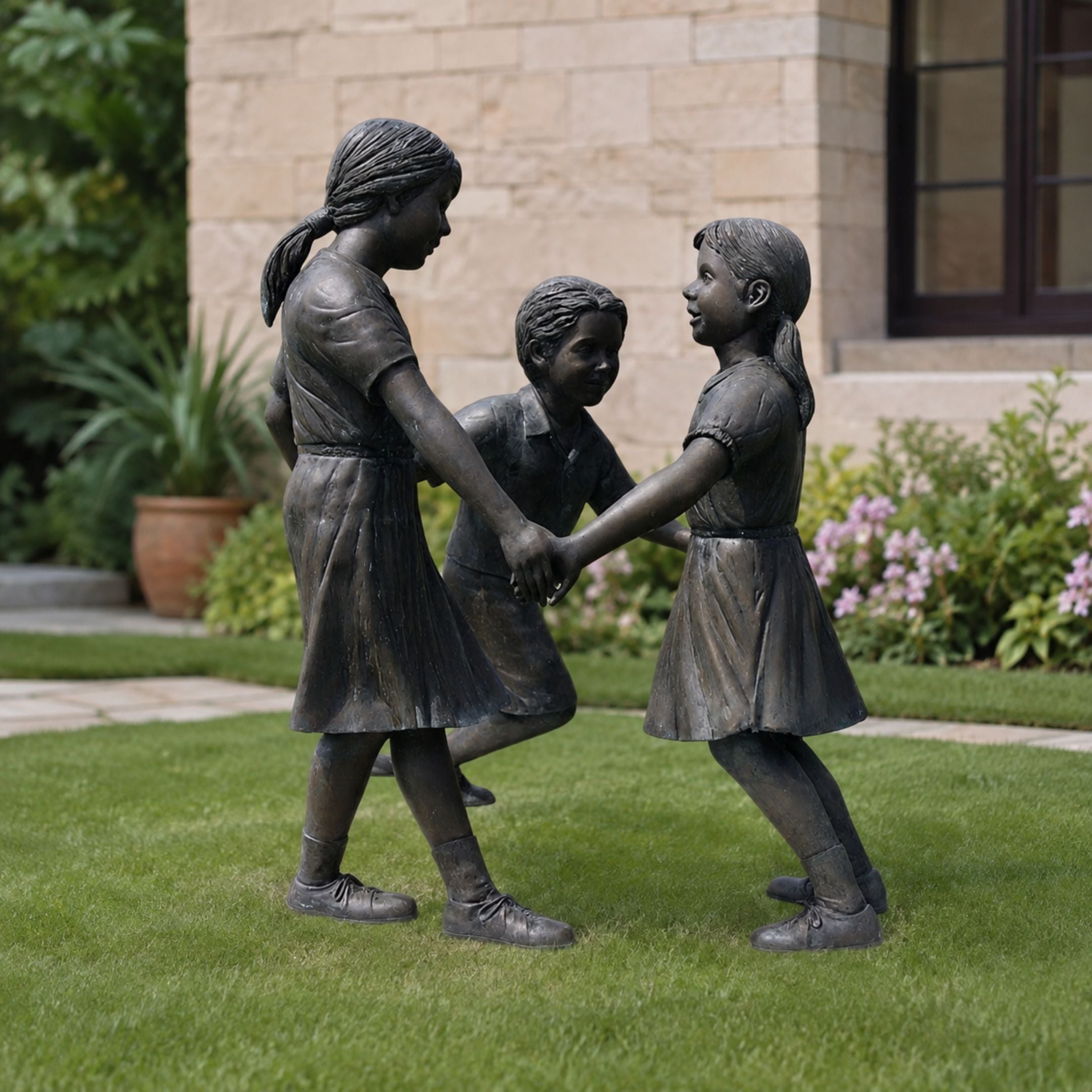 Life-Size Traditional Children Playing Bronze Sculpture, 130cm, three child figures holding hands in a ring on grass, set in a garden by Giant Sculptures.