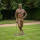 Life-Size Traditional Male Golfer Bronze Sculpture by Giant Sculptures shown on a lawn, in flat cap and knickerbockers, leaning on a golf club.