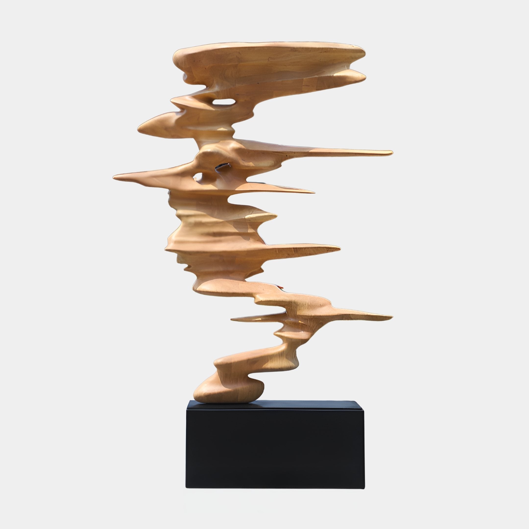 Tempest Drift Natural Abstract Wood Sculpture by Giant Sculptures, stacked honey-toned wave ribbons on a black plinth against a plain white background.