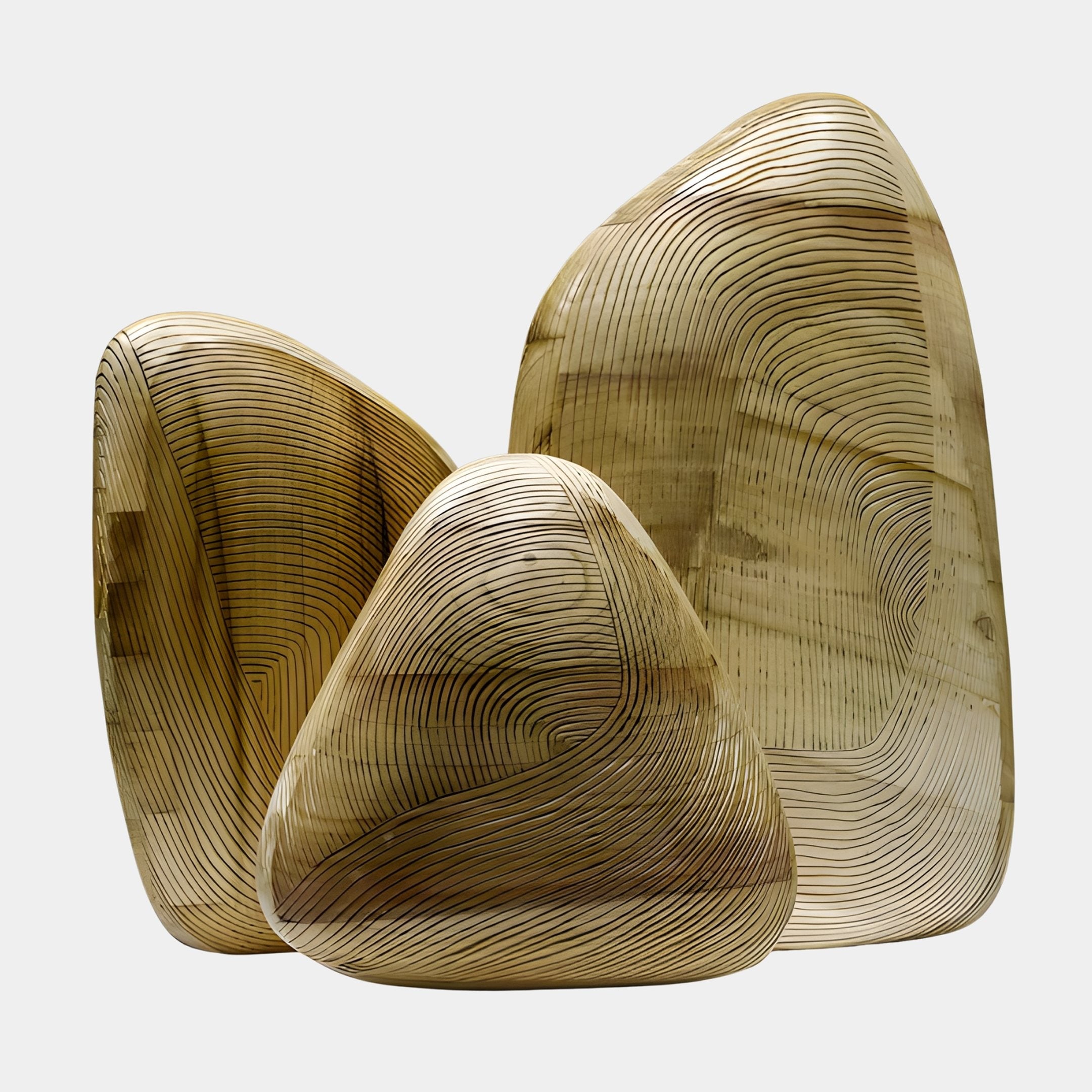 Pebble Trio Gold Abstract Wood Sculpture Set by Giant Sculptures, three hand-carved pebble forms in honey-gold tones with concentric contour-line incisions, on white.