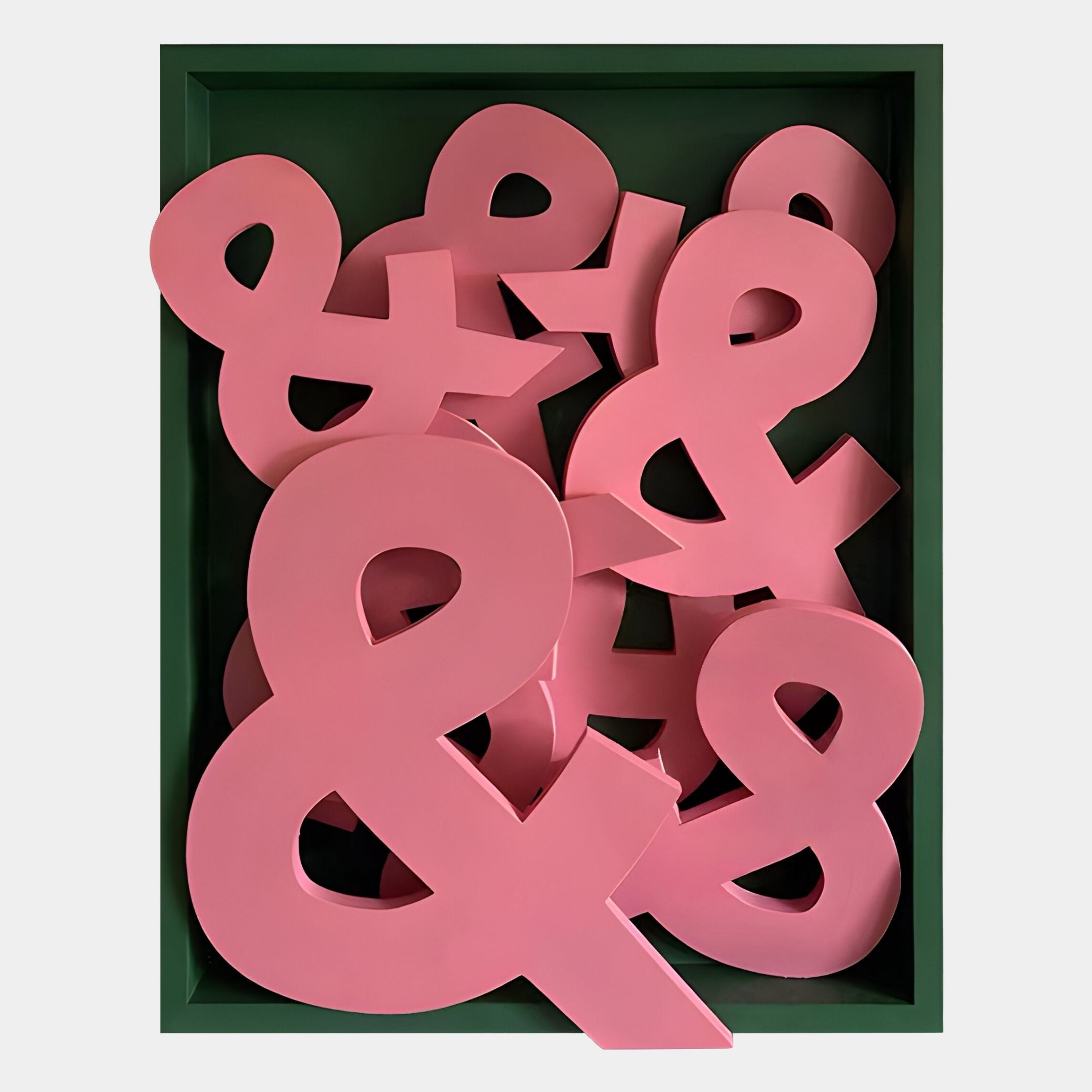 The Typova Pink Ampersand Wood Carving 3D Wall Art by Giant Sculptures features a green tray with layered pink ampersands—an eye-catching, unique accent for your wall decor.
