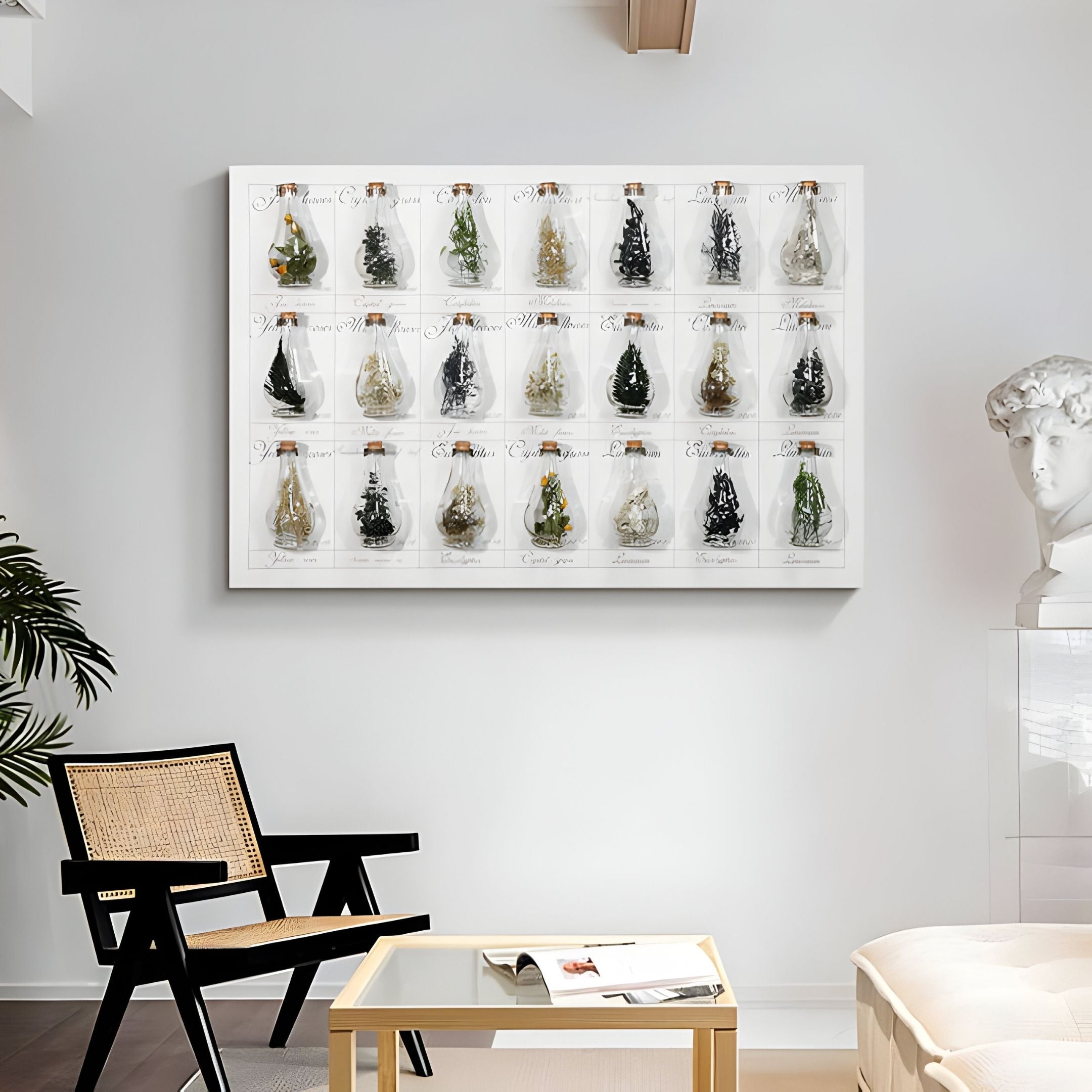 A modern living room features a beige chair, light wood table, potted plant, and a white wall adorned with Giant Sculptures' Archivelle Botanical Catalogue Glass Bottle 3D Wall Art arranged in a grid. A classical bust sculpture sits gracefully in the corner.