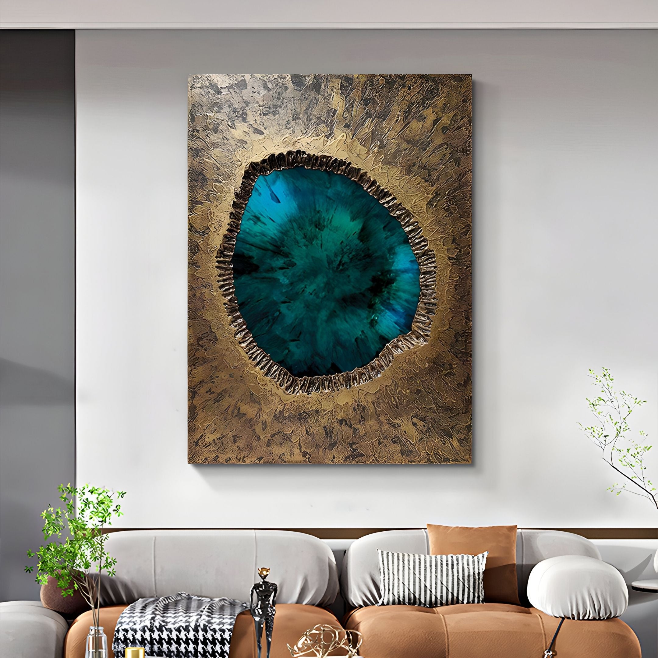 The Vorthera Emerald Burst Textured Gold 3D Wall Art by Giant Sculptures features vivid blue and green gemstone-inspired design in a large textured gold frame, displayed above a beige sofa with decorative cushions in a modern living room.