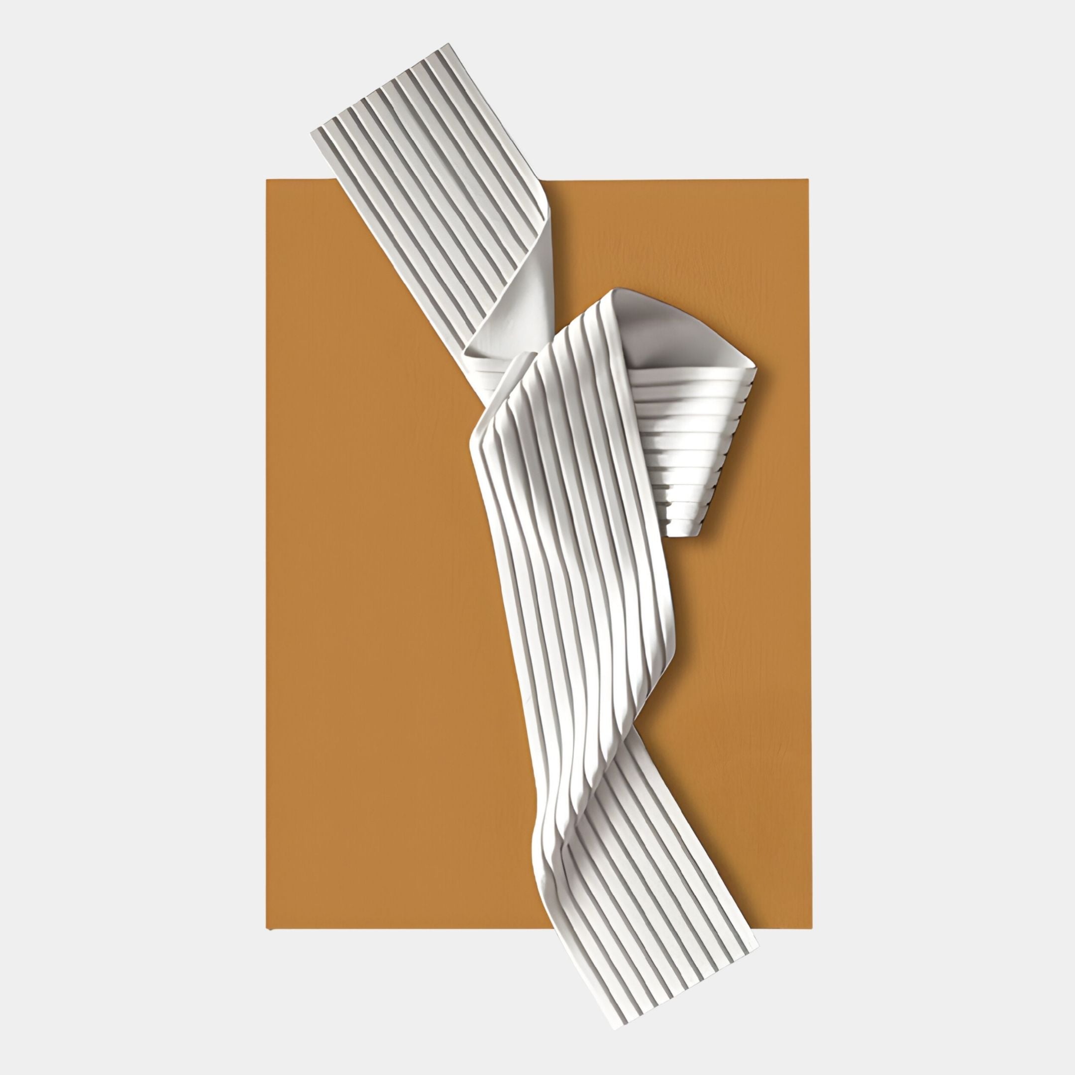 The Arcluma Amber Folded Ribbon Leather 3D Wall Art by Giant Sculptures features a pleated white ribbon form over a mustard rectangular base, creating a bold, modern statement for contemporary interiors. Displayed on a plain light gray backdrop.