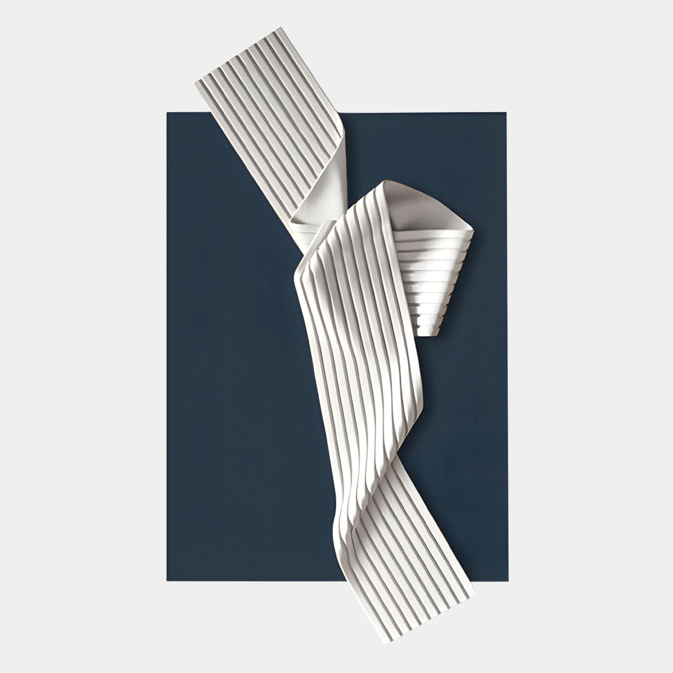 The Arcluma Midnight Blue Folded Ribbon Leather 3D Wall Art by Giant Sculptures features ribbed white leather folded diagonally over a deep blue backdrop, adding dynamic texture and movement to any contemporary space.