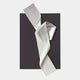 The Arcluma Charcoal Folded Ribbon Leather 3D Wall Art by Giant Sculptures features a striking white, pleated ribbon design crossing a black background, creating bold, minimalist decor for any modern space.