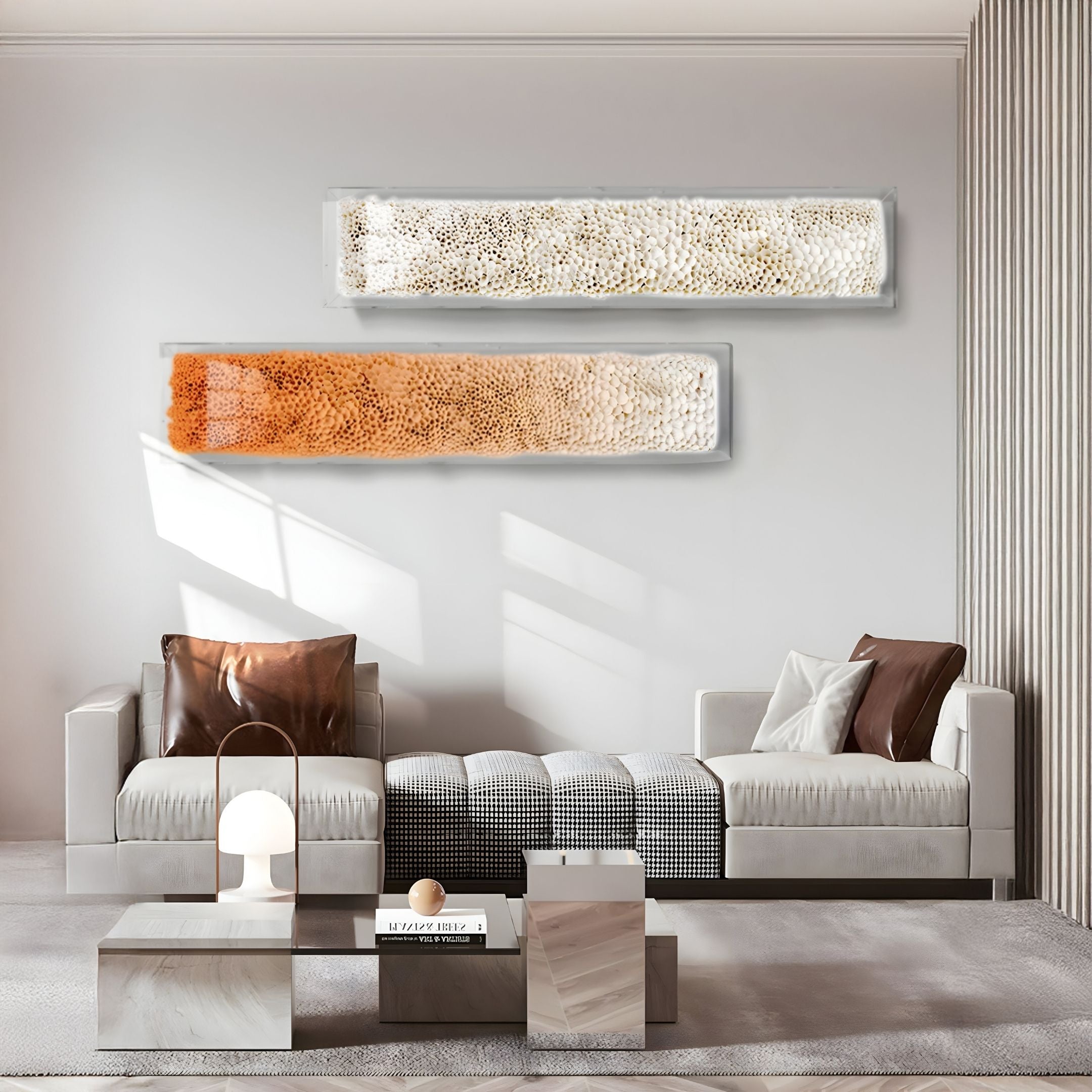 Modern living room with two beige sofas, brown accent pillows, a low checkered ottoman, geometric coffee tables, a small lamp, and Giant Sculptures' Aeraline Amber Fade Vertical Gradient Leather 3D Wall Art above the sofa. Sunlight casts shadows on the wall.