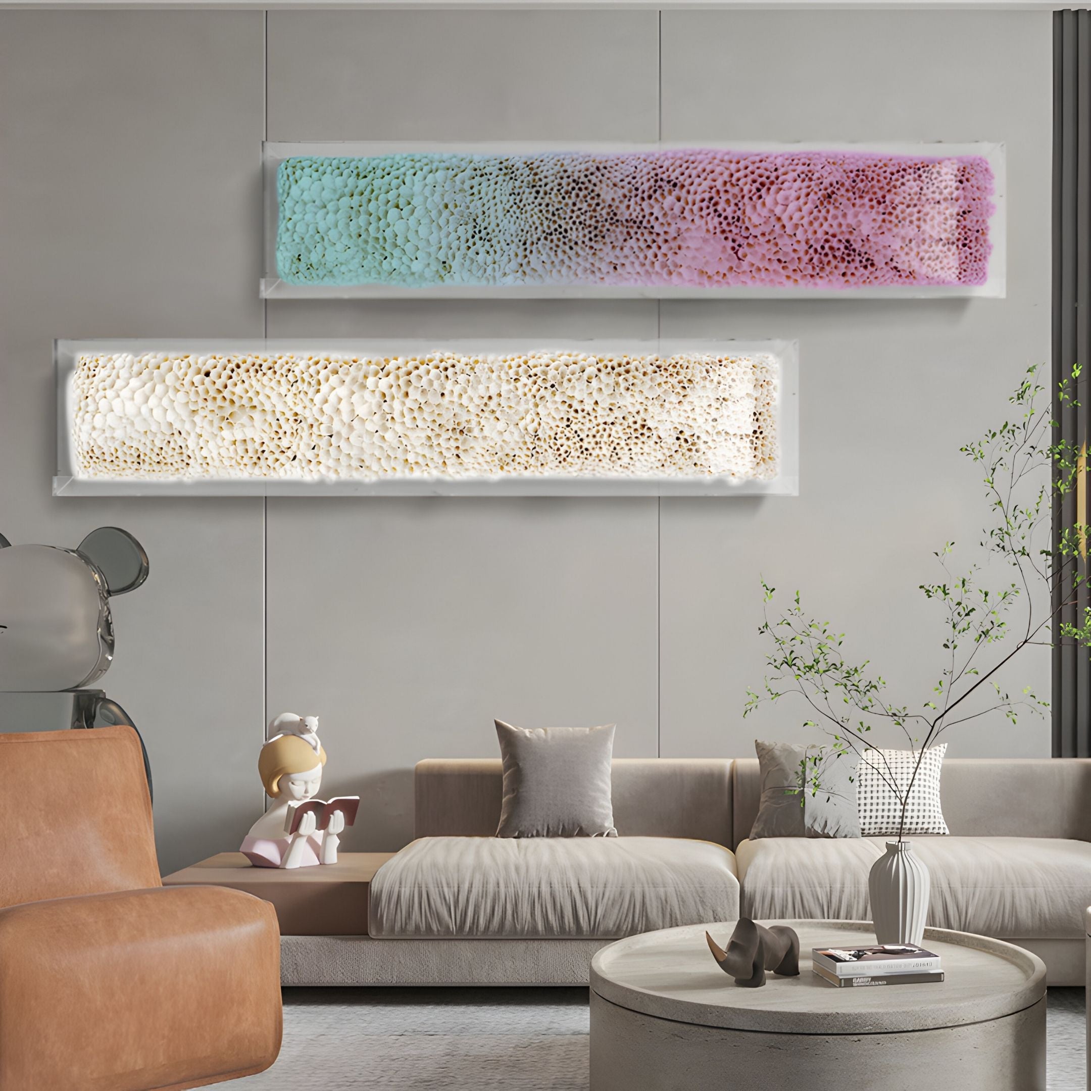 Modern living room with beige couches, brown chair, minimalist decor, small tree, and Giant Sculptures' Aeraline Rose Mist Vertical Gradient Leather 3D Wall Art on a gray wall. A child figurine sits reading a book.