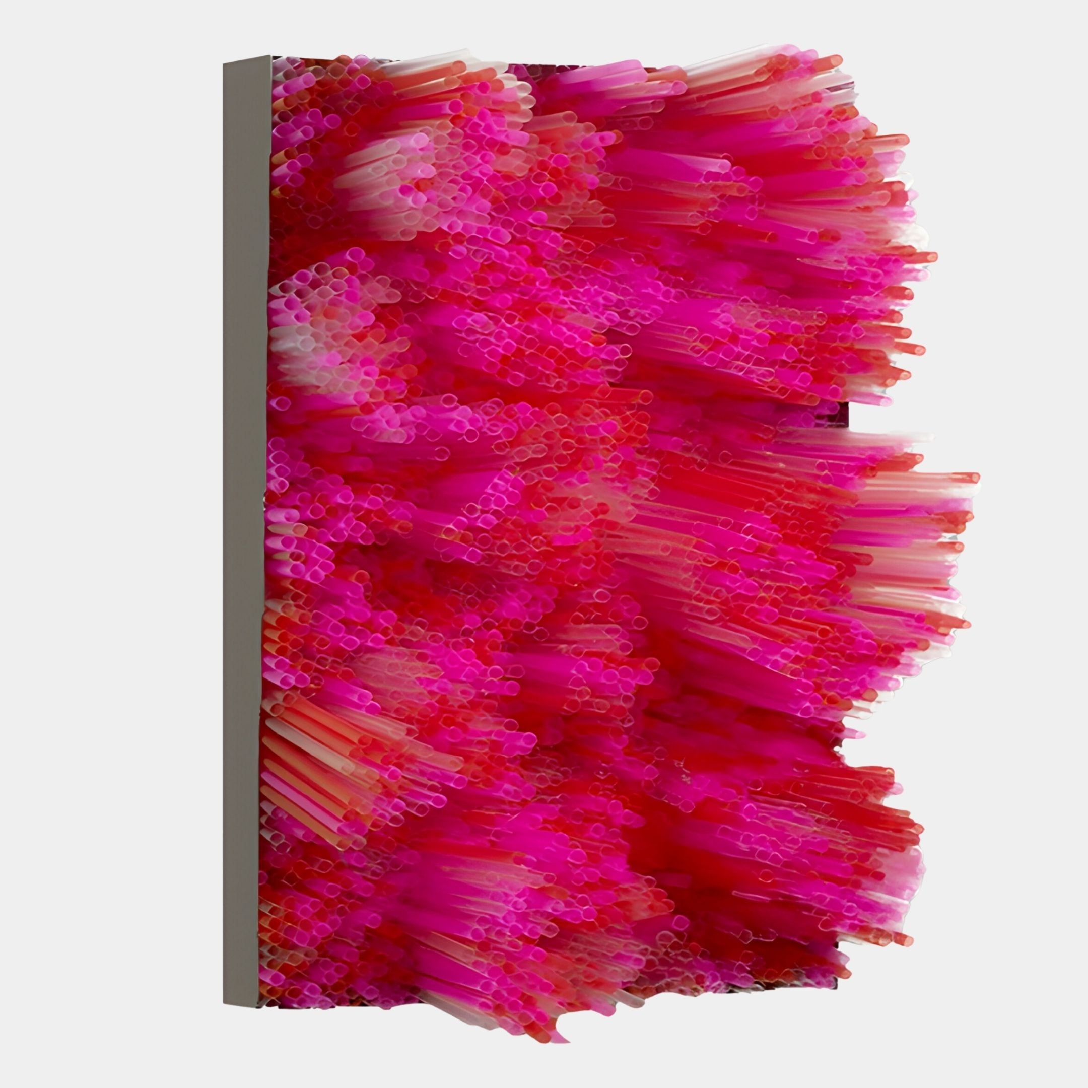 The Chromavolt Fuchsia Burst Straw 3D Wall Art by Giant Sculptures features tightly packed pink and red straws, forming a vibrant, spiky surface that adds striking texture and color to any modern space against a plain white background.