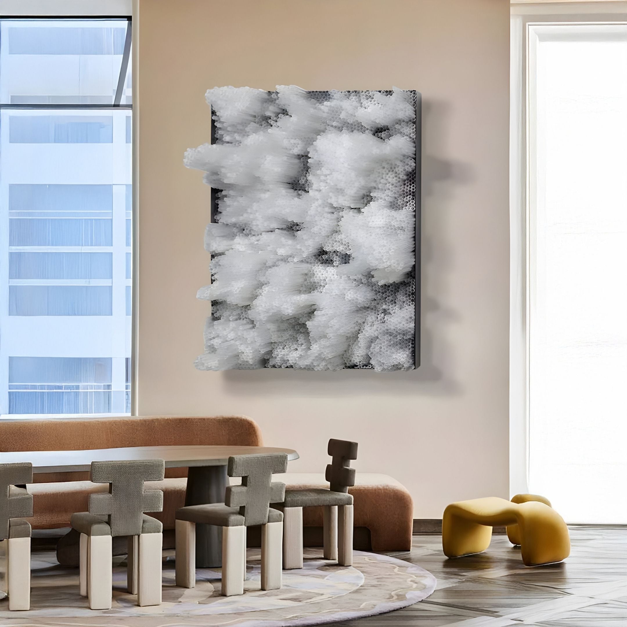 A modern living space with tall windows, a brown curved sofa, gray chairs around a round table, a yellow sculptural bench, and Chromavolt Frosted White Cluster Straw 3D Wall Art by Giant Sculptures as striking contemporary wall decor.