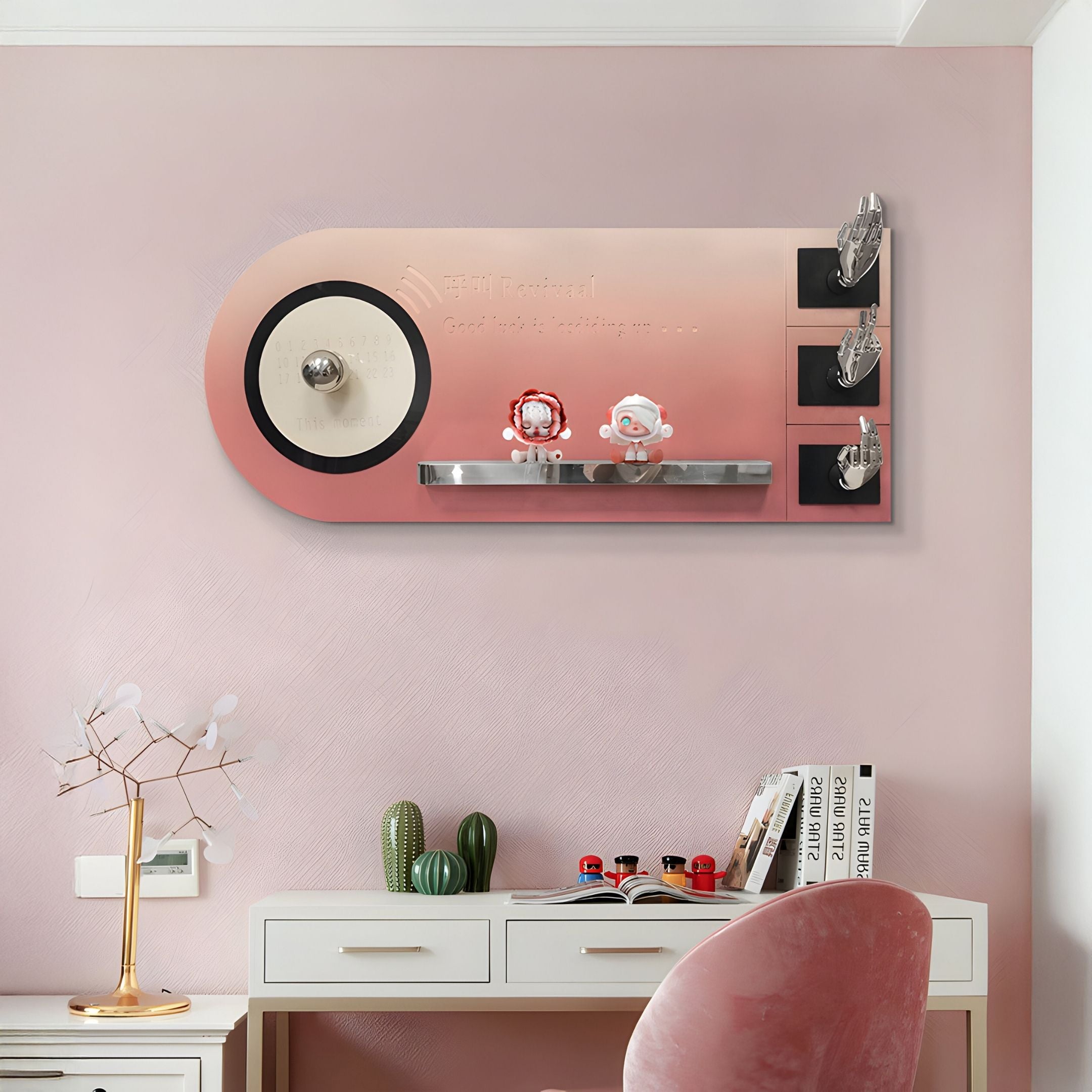 The Nexivra Rose Gradient Techscape Interactive 3D Wall Art by Giant Sculptures features a pink gradient, cartoon figurines, metallic accents, and English text—ideal for tech-inspired kids’ rooms. Below sits a console table with books, cacti, and a geometric lamp.