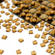 Lumicast Gold Cascade Crystal Lens 3D Wall Art by Giant Sculptures showcases small, faceted amber gems scattered on white, with a grid pattern in the corner—ideal for elevating modern interiors with luxury and style.