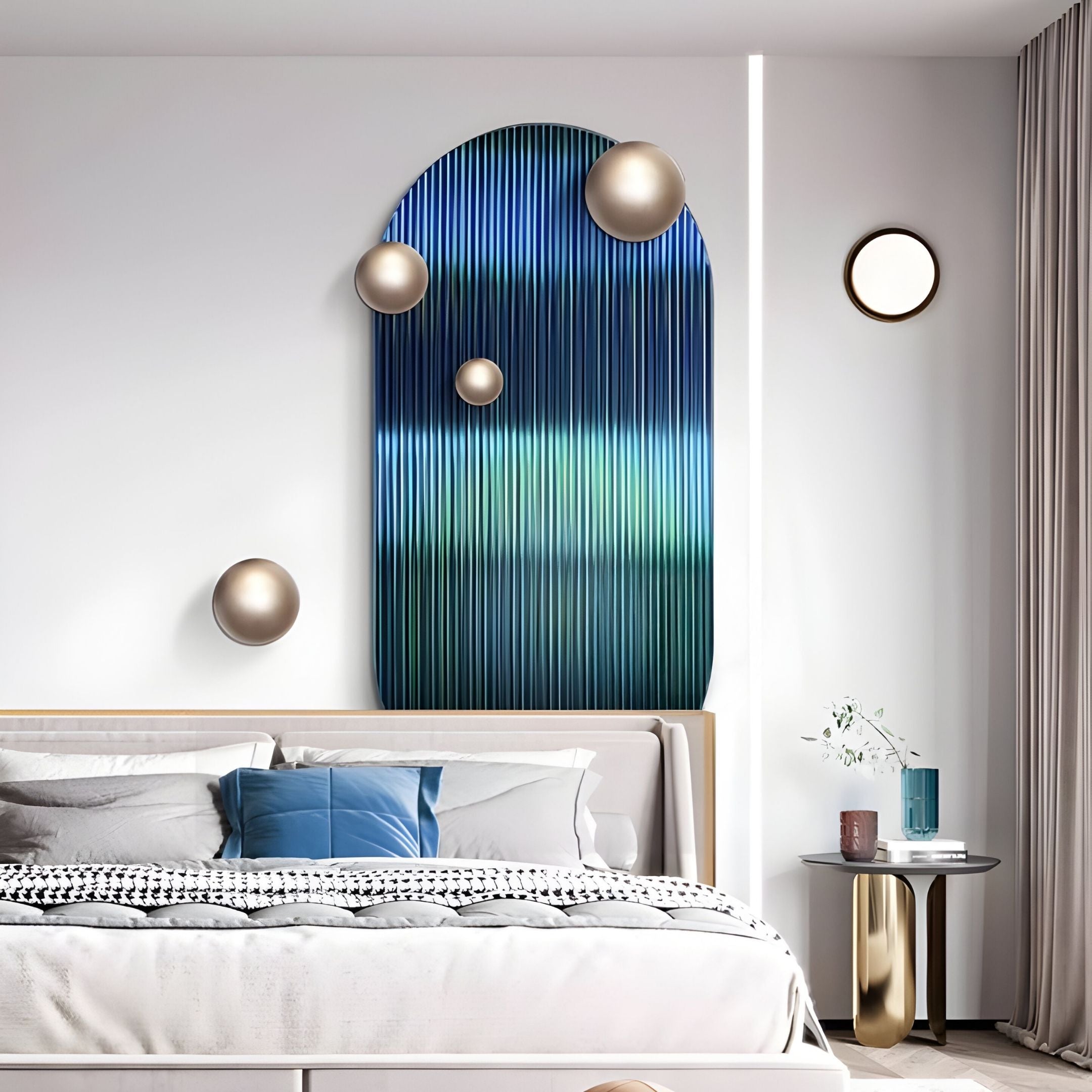 A modern bedroom features a gray bed with blue and white bedding, framed by light gray curtains. The highlight is Giant Sculptures’ Virellon Blue Gradient 3D Wall Art with champagne metal balls, plus a side table with a vase of flowers.