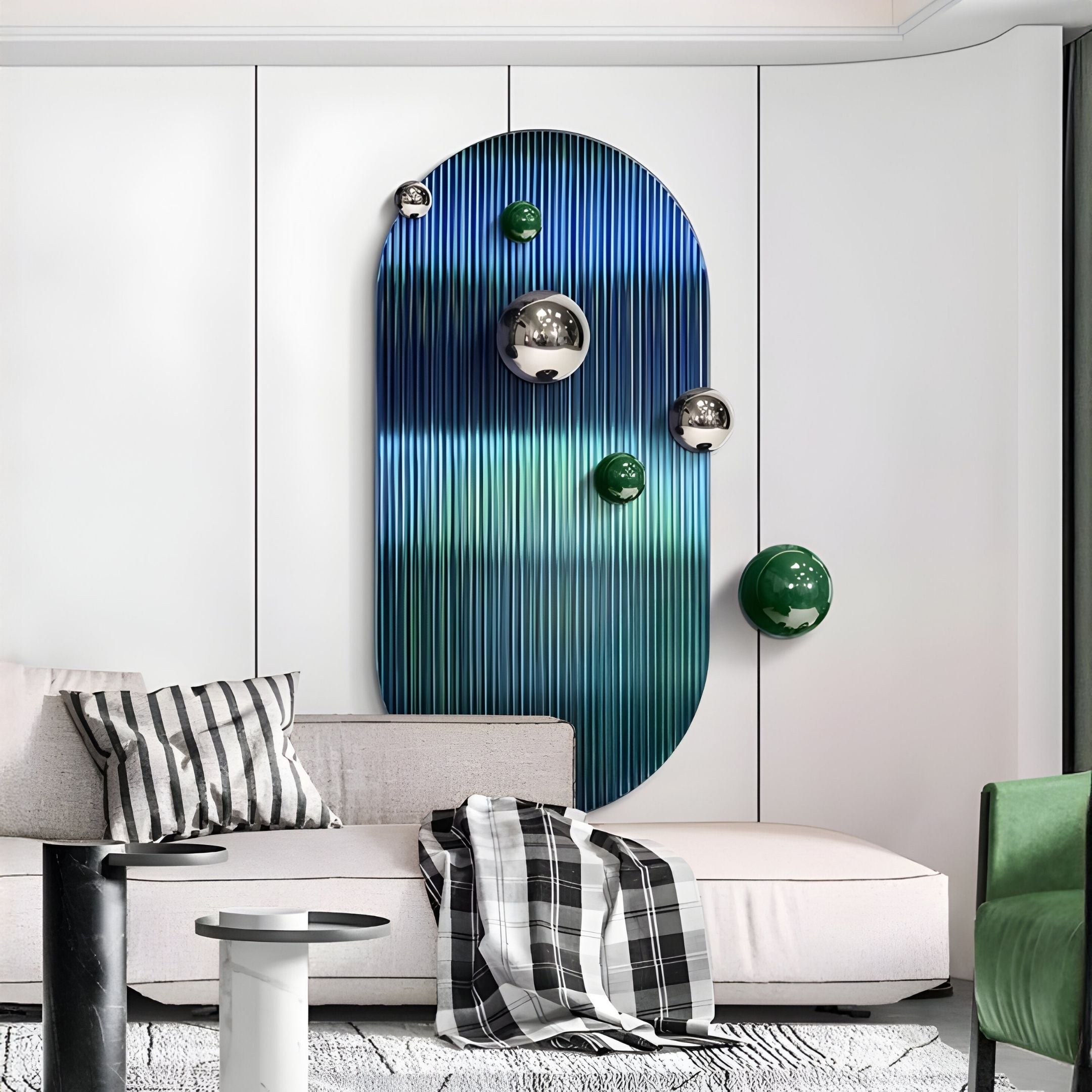 A modern living room with a white sectional sofa, plaid and striped cushions, and a green chair. The wall displays Giant Sculptures’ Virellon Blue Gradient 3D Wall Art with silver and green metal balls, elevating the contemporary decor.