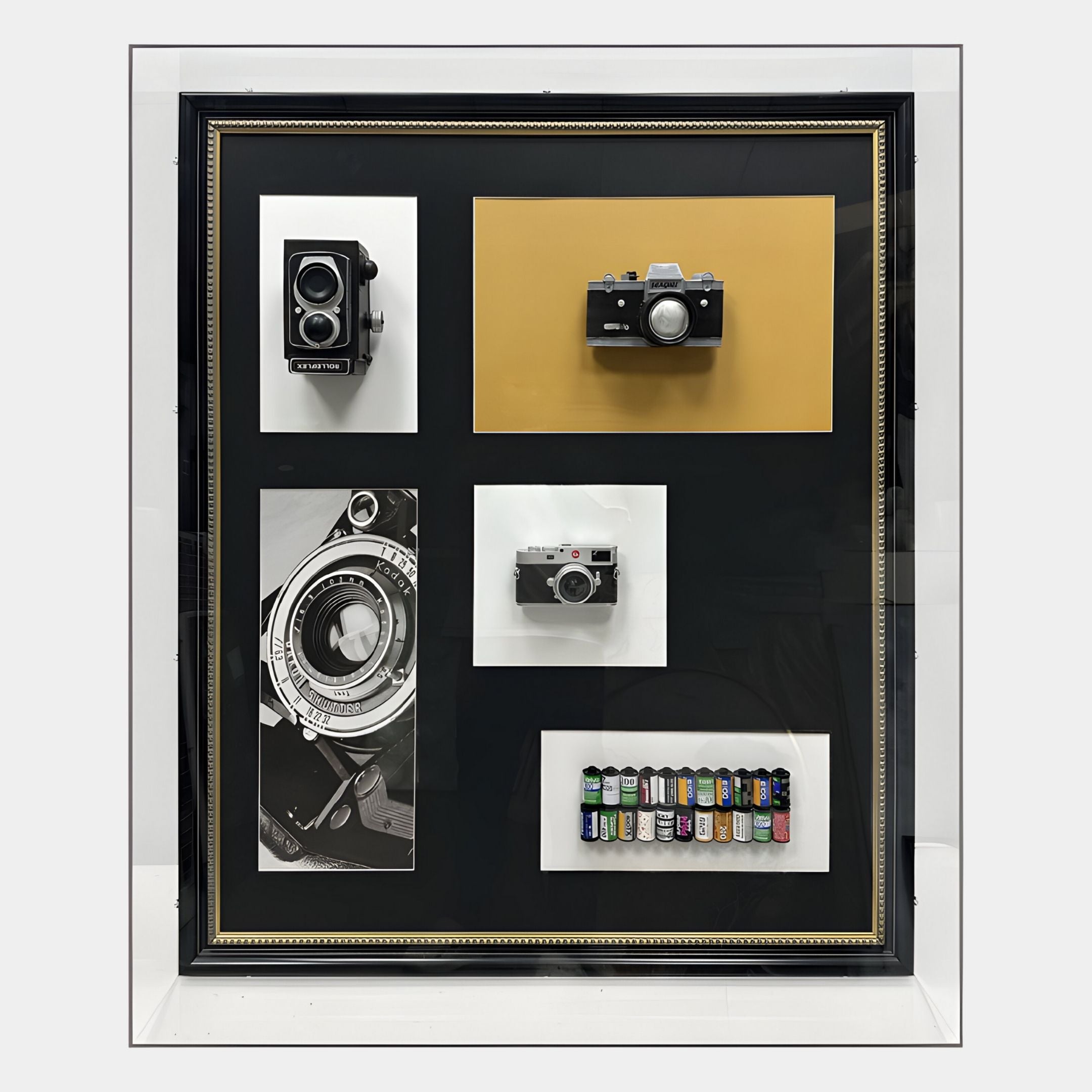 The Fotera Vintage Camera Acrylic Box 3D Wall Art by Giant Sculptures features film rolls and a monochrome camera lens on a black and gold background—an elegant choice for any analogue photography display.