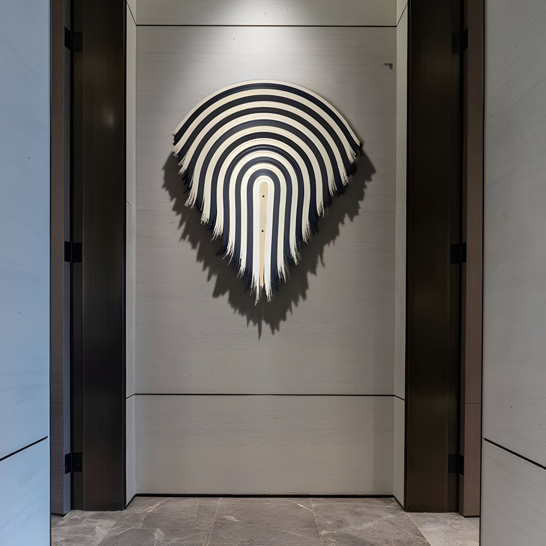 The Arclune Black & White Stripe Sculptural Felt 3D Wall Art by Giant Sculptures features a modern teardrop design with frayed edges, perfect for wabi-sabi interiors, and is shown mounted on a light gray wall with dark metal accents.