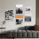 A modern living room featuring Giant Sculptures' Framegrid Orange Mixed-Size Gallery 6-Set Acrylic Wall Art—a sleek display of five black-and-white prints and one with an orange accent, all in minimalist frames—completes the stylish space.