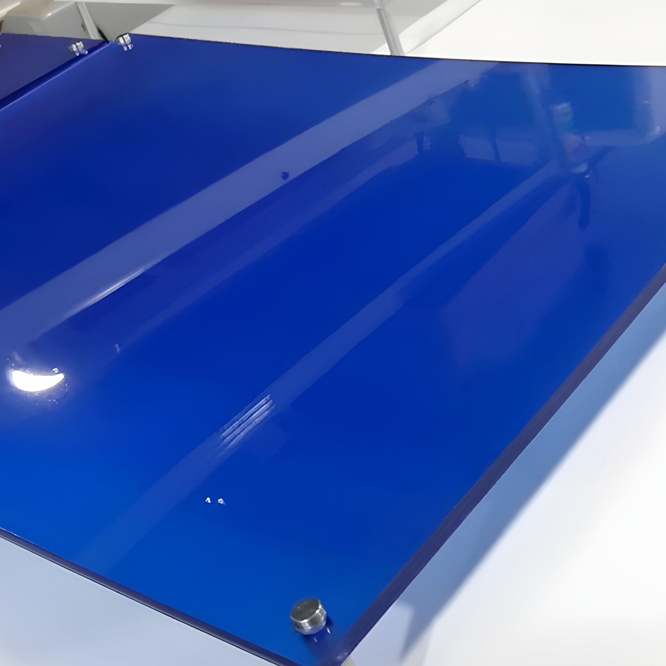 The Framegrid Blue Mixed-Size Gallery 5-Set Acrylic Wall Art by Giant Sculptures features glossy blue acrylic pieces with a sleek rectangular design, secured by metallic screws—ideal for minimalist decor and beautifully reflecting surrounding light.