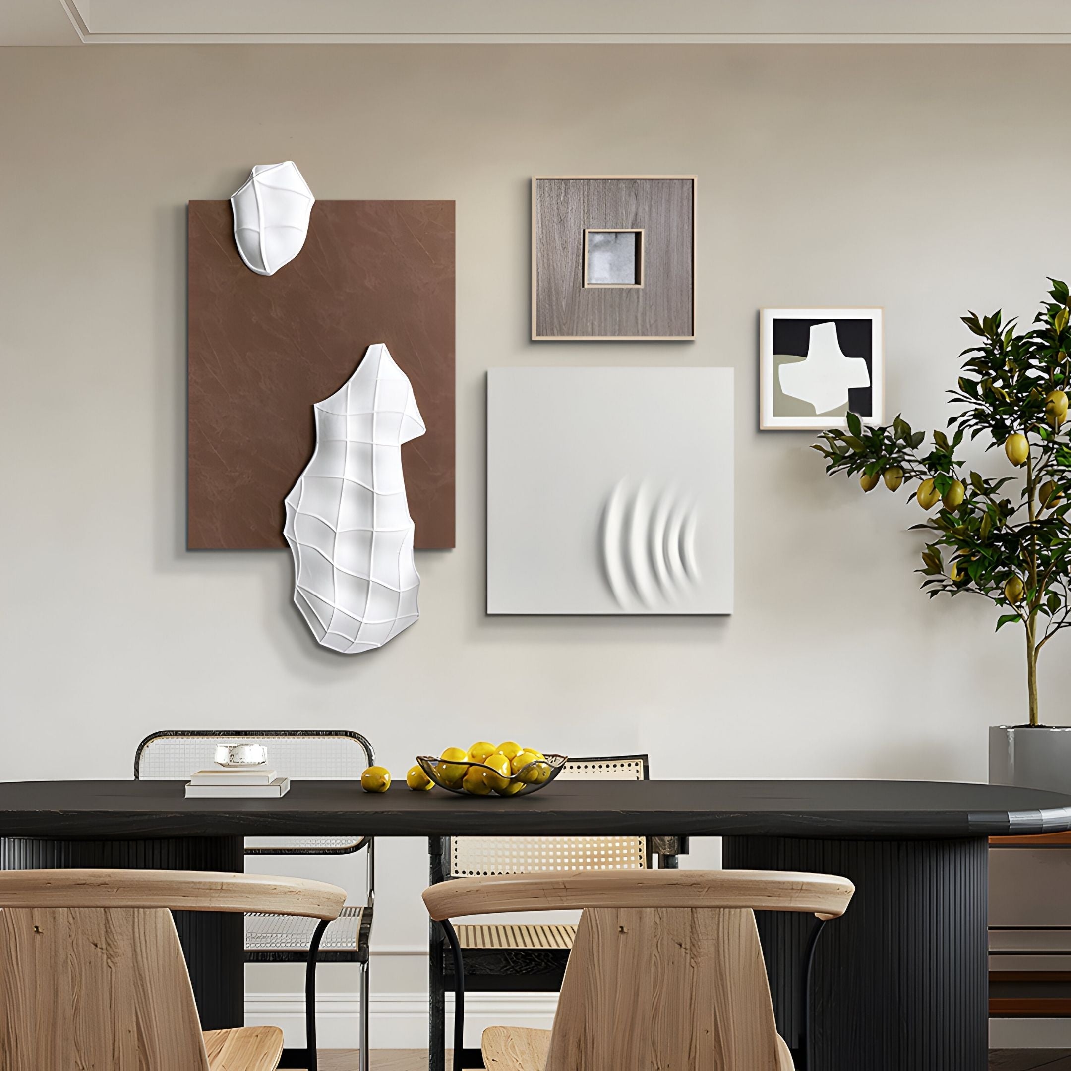 A modern dining area features a black table, wooden chairs, a bowl of lemons, and the Mirello 4-Set Neutral Sculptural Textured 3D Wall Art by Giant Sculptures. A potted lemon tree adds greenery to this serene, minimalist space.