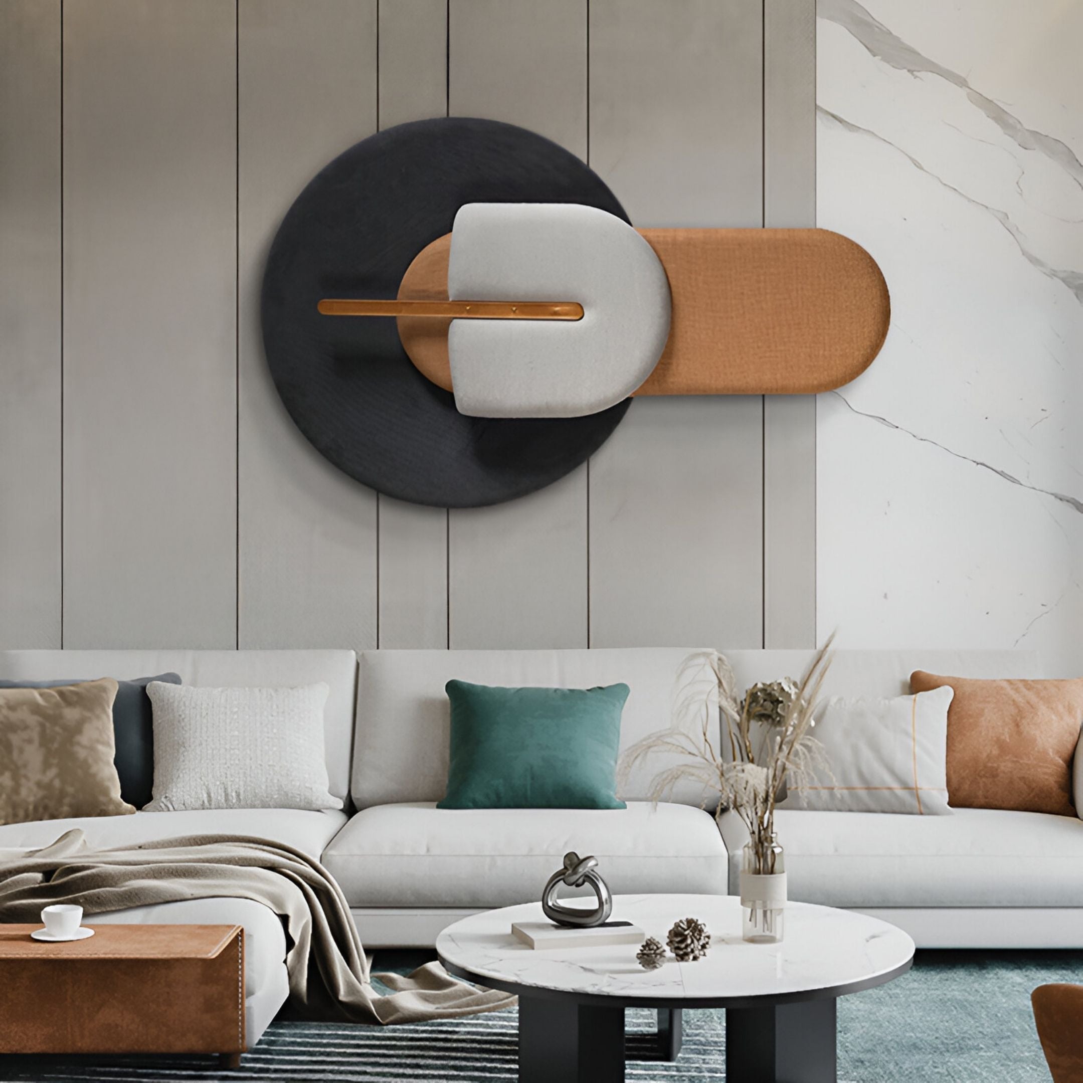 Modern living room with a light gray sectional, colorful pillows, a round marble coffee table, and the Solvia Black & Bronze Layered Geometry 3D Wall Art by Giant Sculptures above the couch. Neutral tones pop with green, gold, and blue accents.